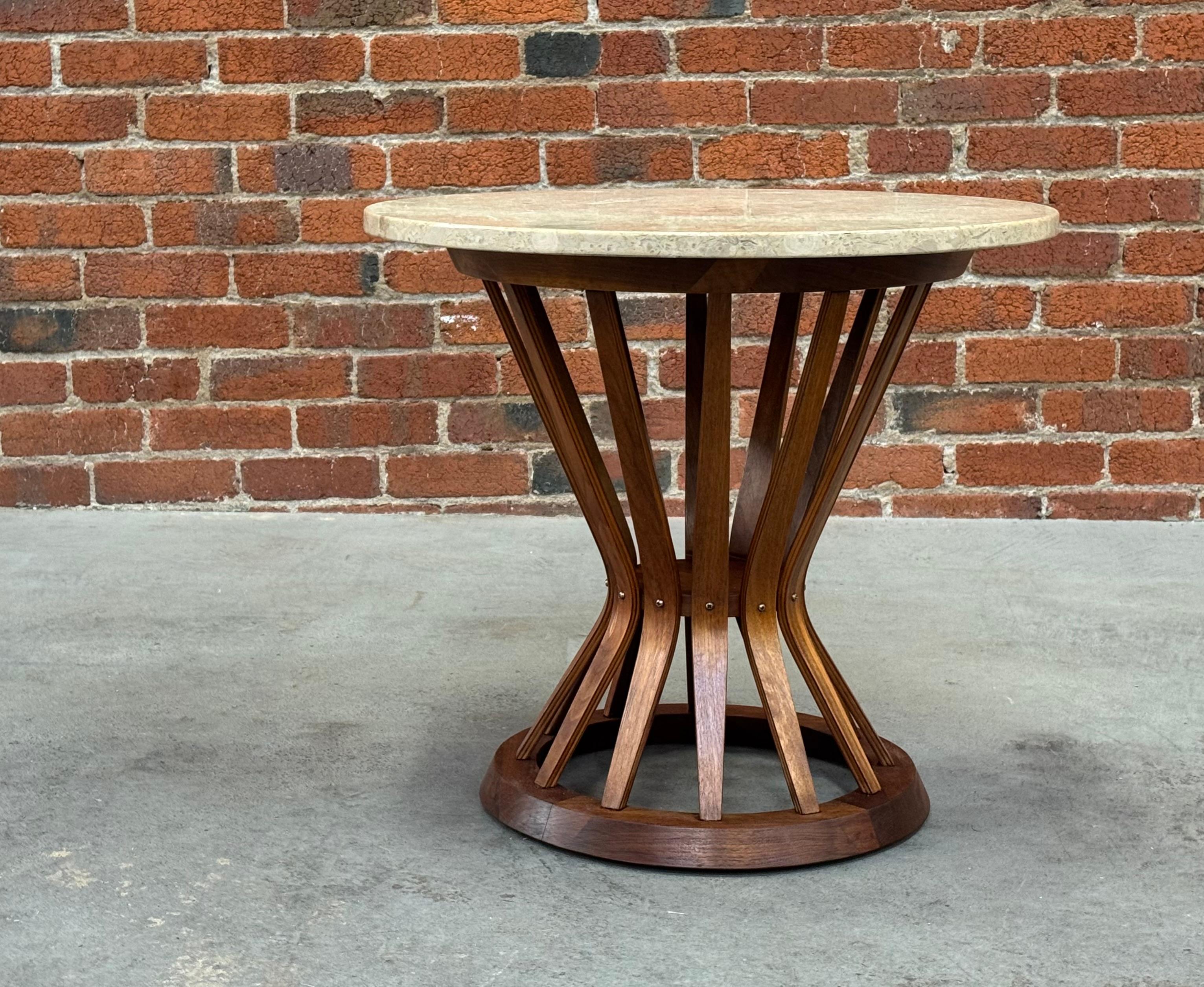 Side table constructed of walnut slats and two circular top and bottom rings held together with brass fasteners, The round top is of travertine with figurative patterns that are naturally occurring in the stone. The table is in the style of the