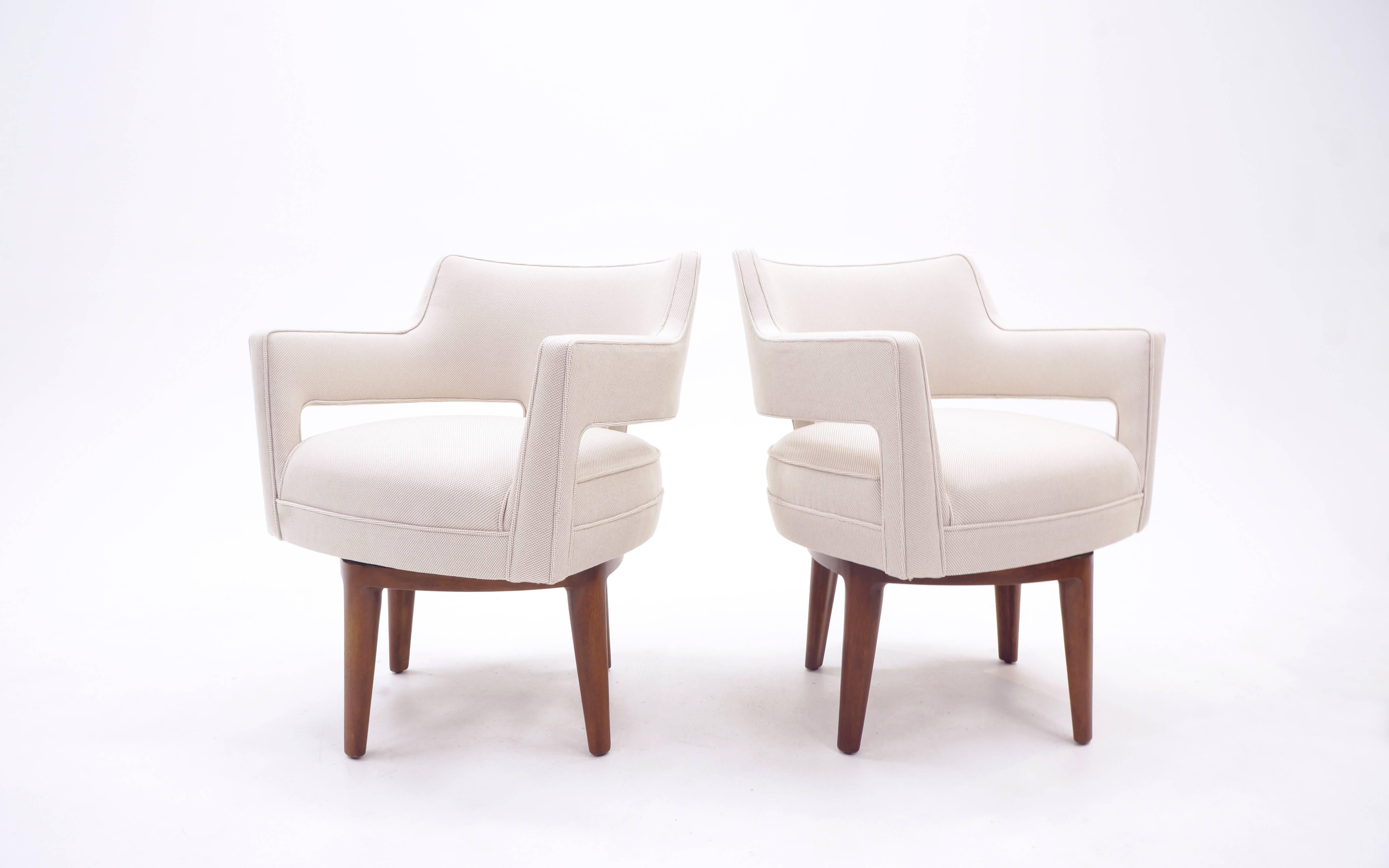 Set of four swivel armchairs designed by Edward Wormley for Dunbar. Dining / kitchen height chairs.  Very comfortable, substantial scale. Look at the detail in this design, both the upholstery and the mahogany legs and base. The subtle angles and