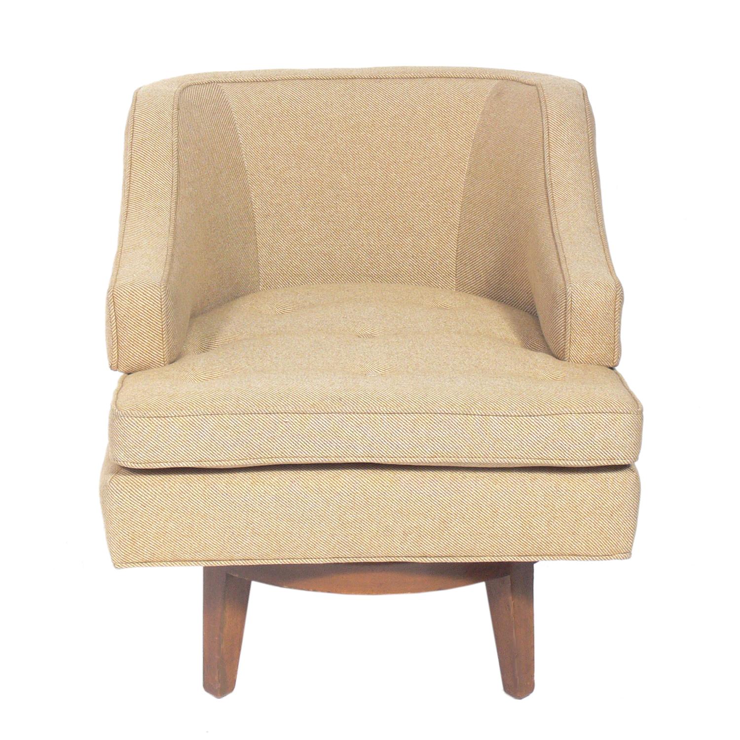 Curvaceous swivel lounge chair, designed by Edward Wormley for Dunbar, American, circa 1950s. This piece is currently being refinished and reupholstered and can be reupholstered in your fabric and refinished in your choice of color. The price noted