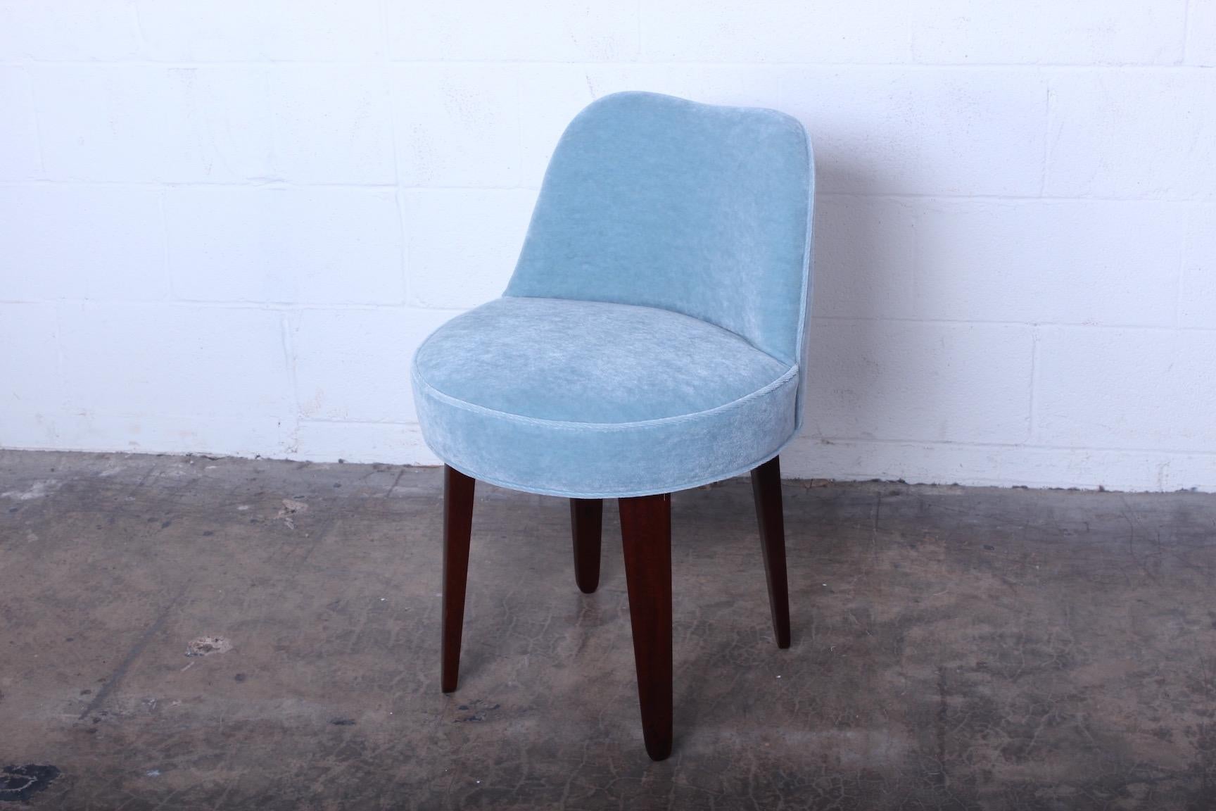 A swiveling vanity stool with mahogany legs and Mohair upholstery. Designed by Edward Wormley for Dunbar.