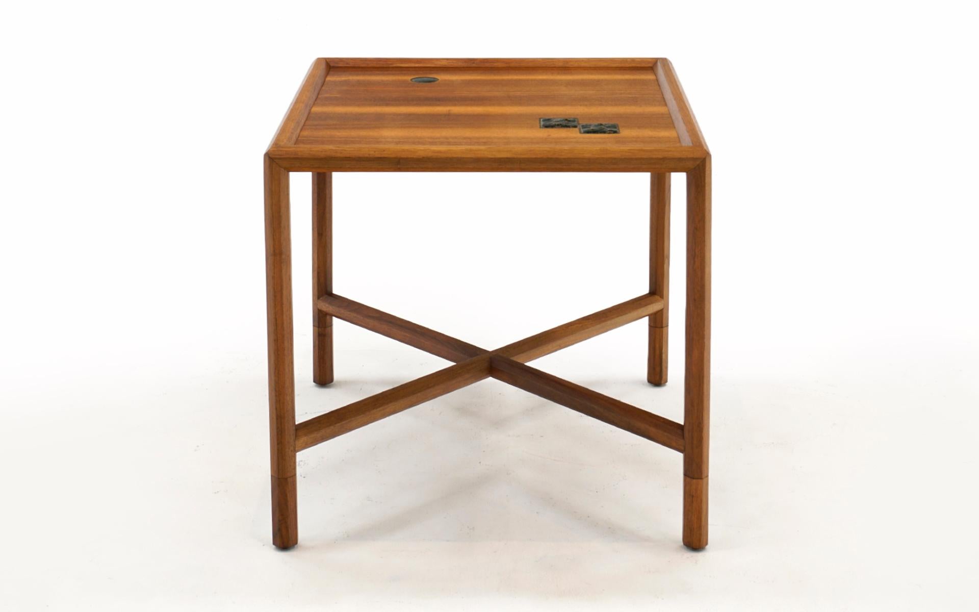 Exquisite side table in African Mahogany with embedded Otto and Gertrude Natzler ceramic tiles designed by Edward Wormley for Dunbar. Look closely at the photos and see the expert craftsmanship. Each leg and the X cross stretchers are hexagonal. The