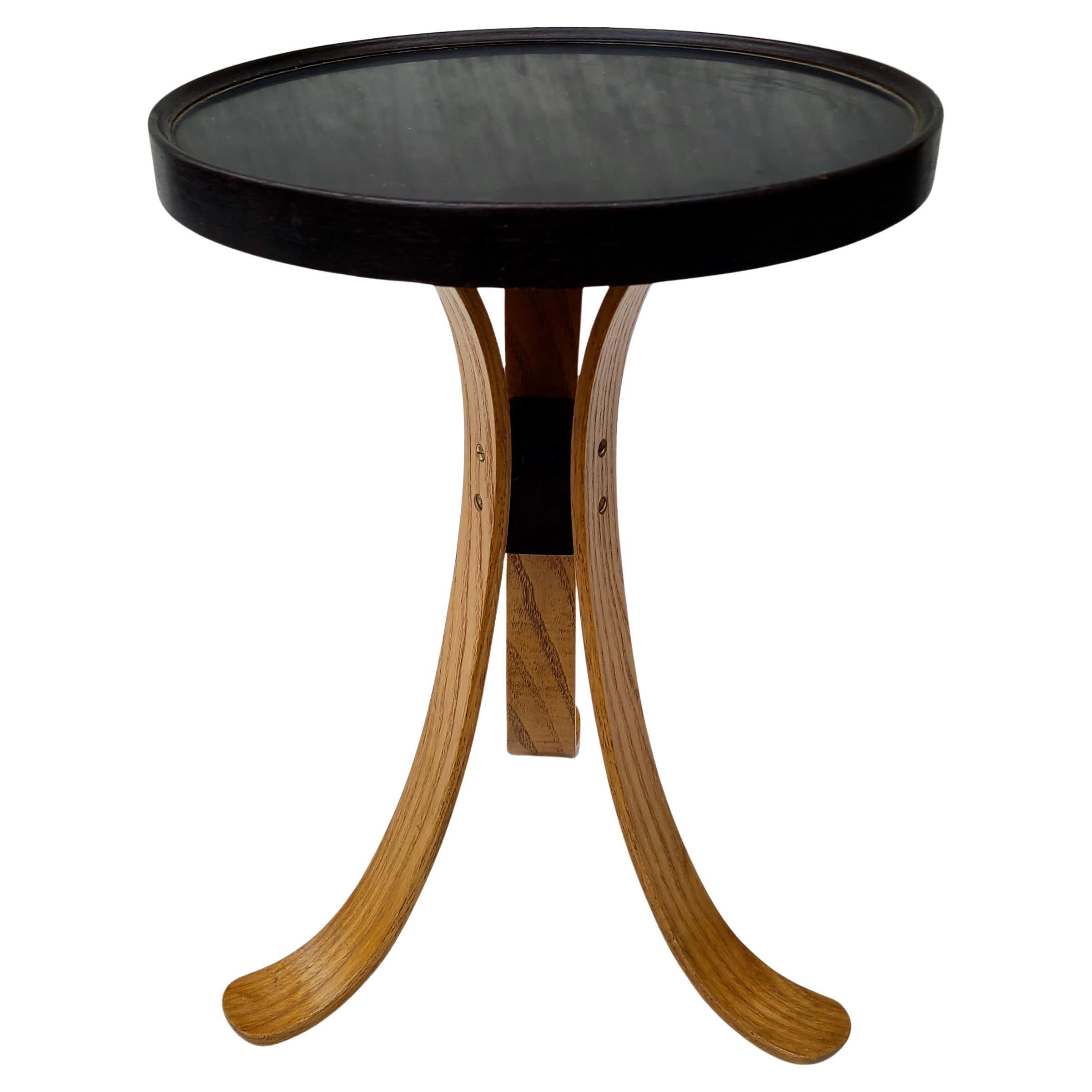 Please feel free to reach out for efficient shipping to your location.

Tripod Table designed by Edward Wormley for Dunbar.
Ebonized Walnut, Ash Legs, Black Formica Top.

