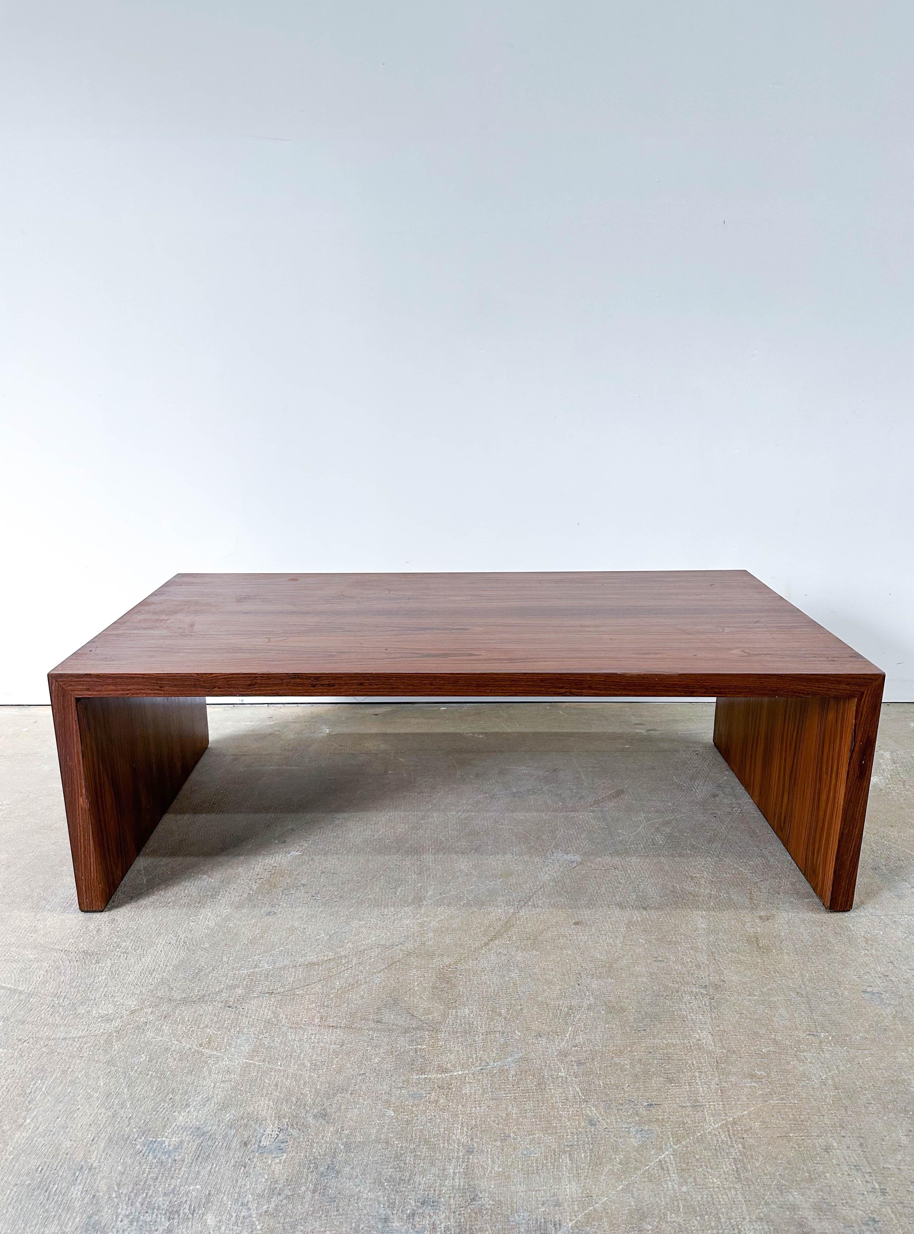 Uncommon Dunbar design in beautiful walnut from the 1960s. Minimalist design is very functional and would make an excellent coffee table or large side table. Very solidly made with some excellent woodgrain. Table top is in great shape. One side of
