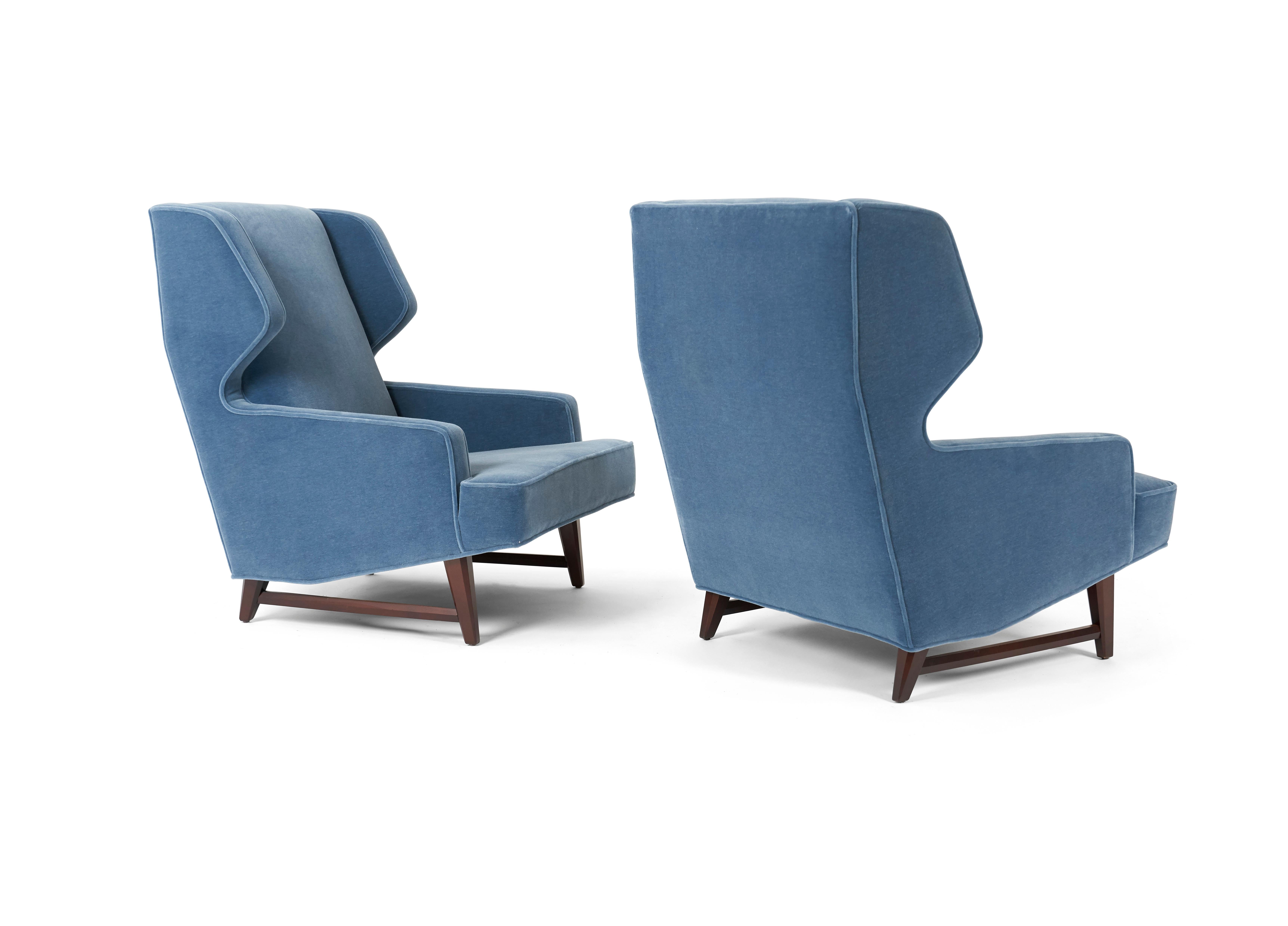Sculptural pair of wing back lounge chairs by Edward Wormley for Dunbar. Fully restored. Refinished walnut bases. 100% angora mohair over new foam.