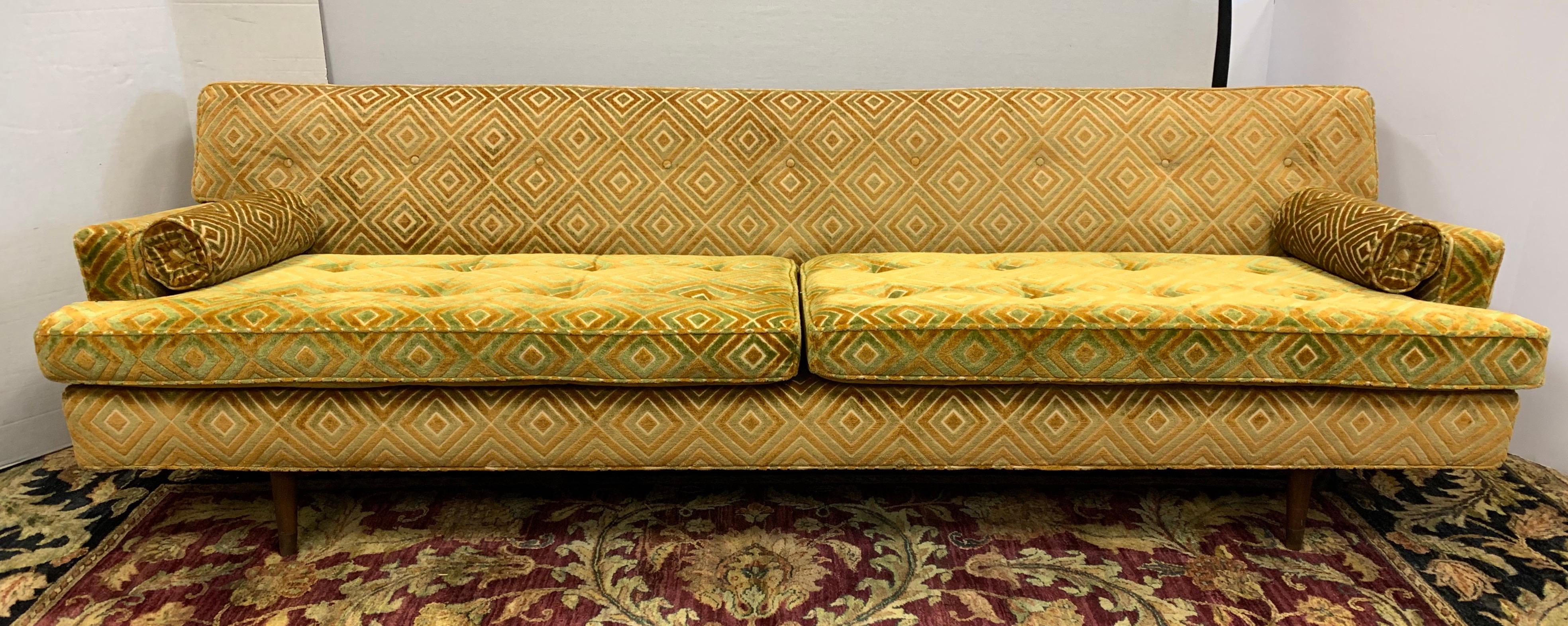 Classic Wormley 8 ft. sofa with gold color upholstery which still appears to be in very good condition. It is so rare to find a Dunbar sofa that is structurally sound and has a geometric fabric. The piece was reupholstered in the 1990s and when it