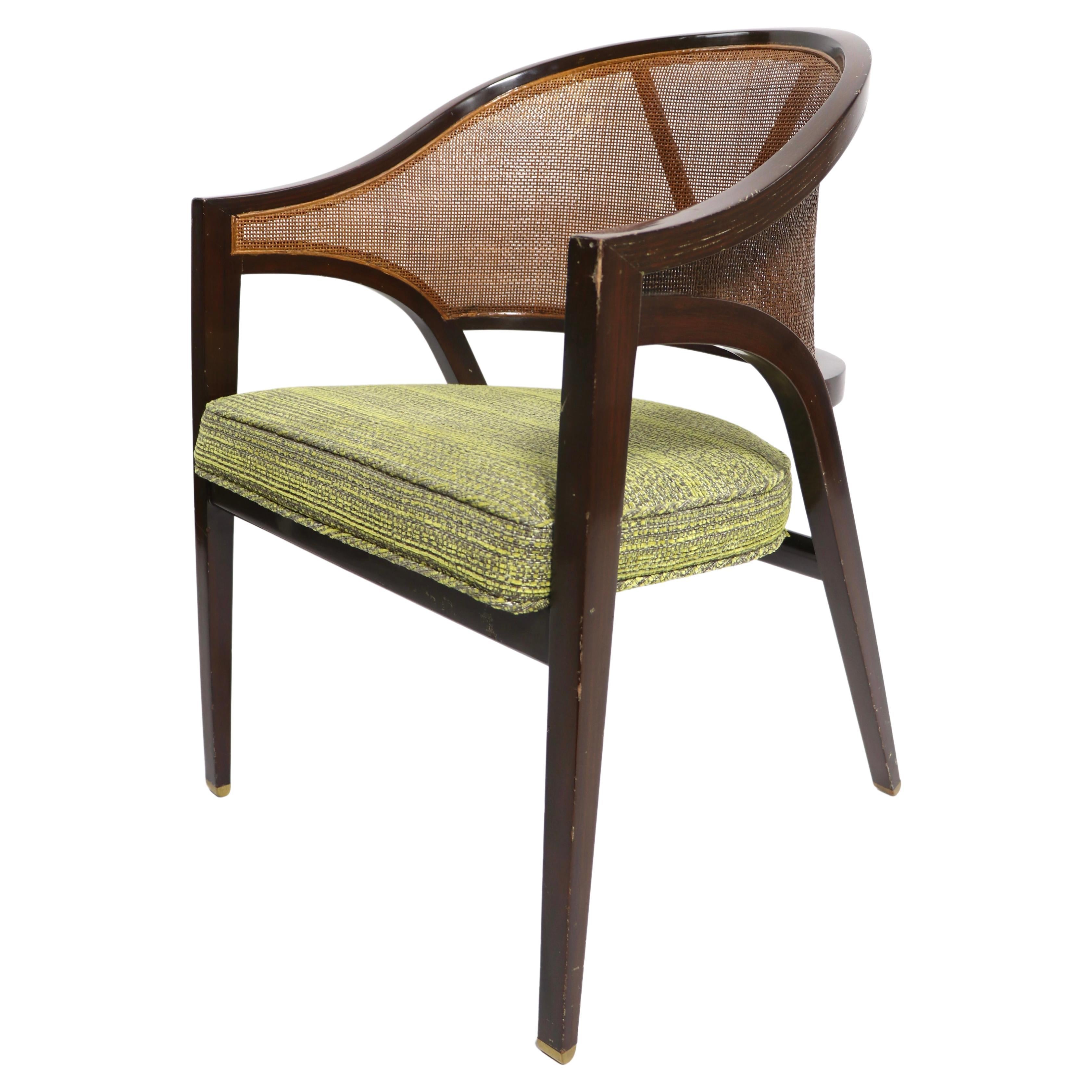 Elegant, sophisticated and chic dining chair, designed by Wormley for Dunbar. The chair features a sculpted walnut frame, caned back and upholstered seat. This example is in good condition, structurally sound and sturdy, it shows cosmetic wear,