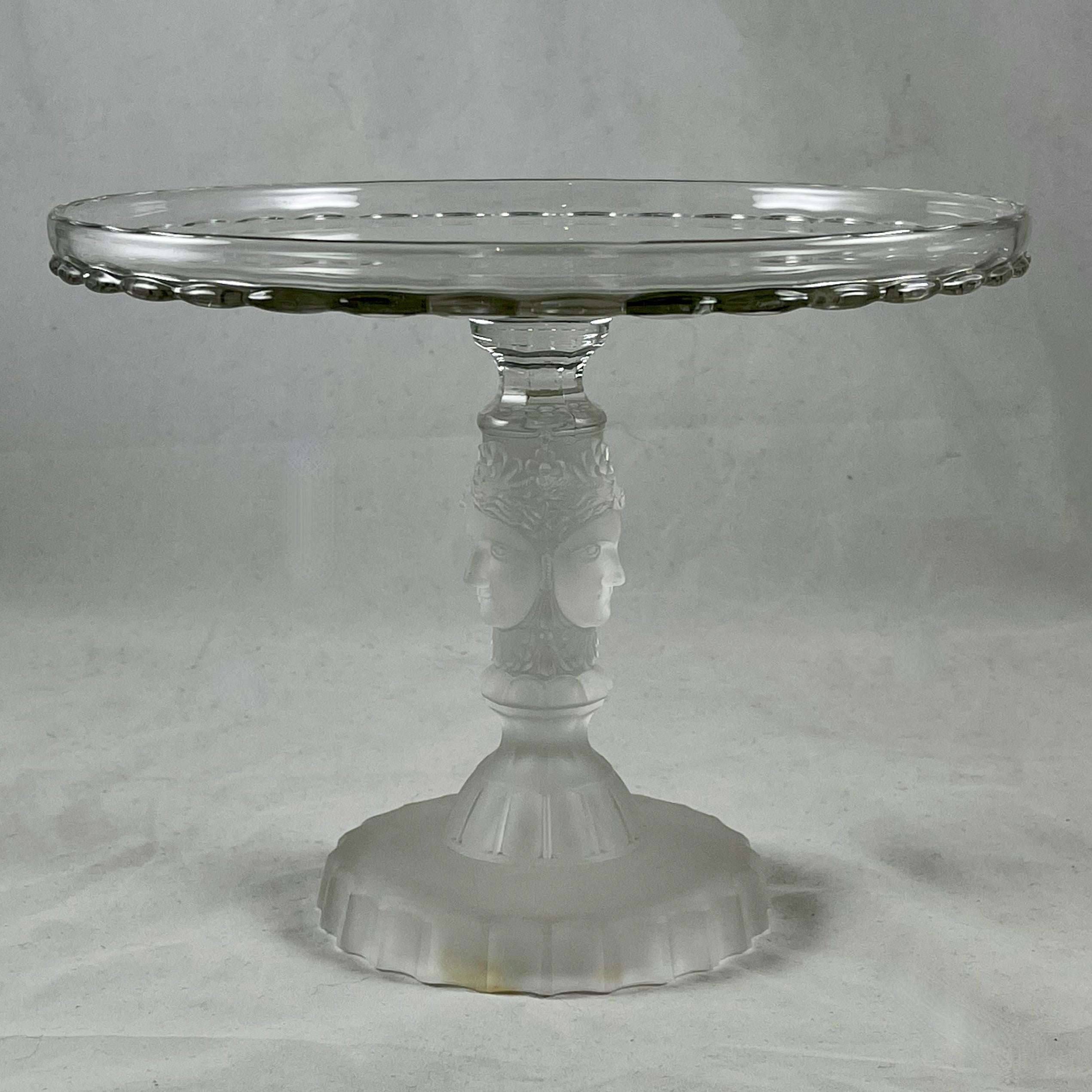 A Three Face early American pressed glass cake stand by Duncan Miller Glass, circa 1880-1890.

The Three Face pattern was designed by J. E. Miller, his most well known design inspired by the profile of his wife Elizabeth Bair Miller. The original