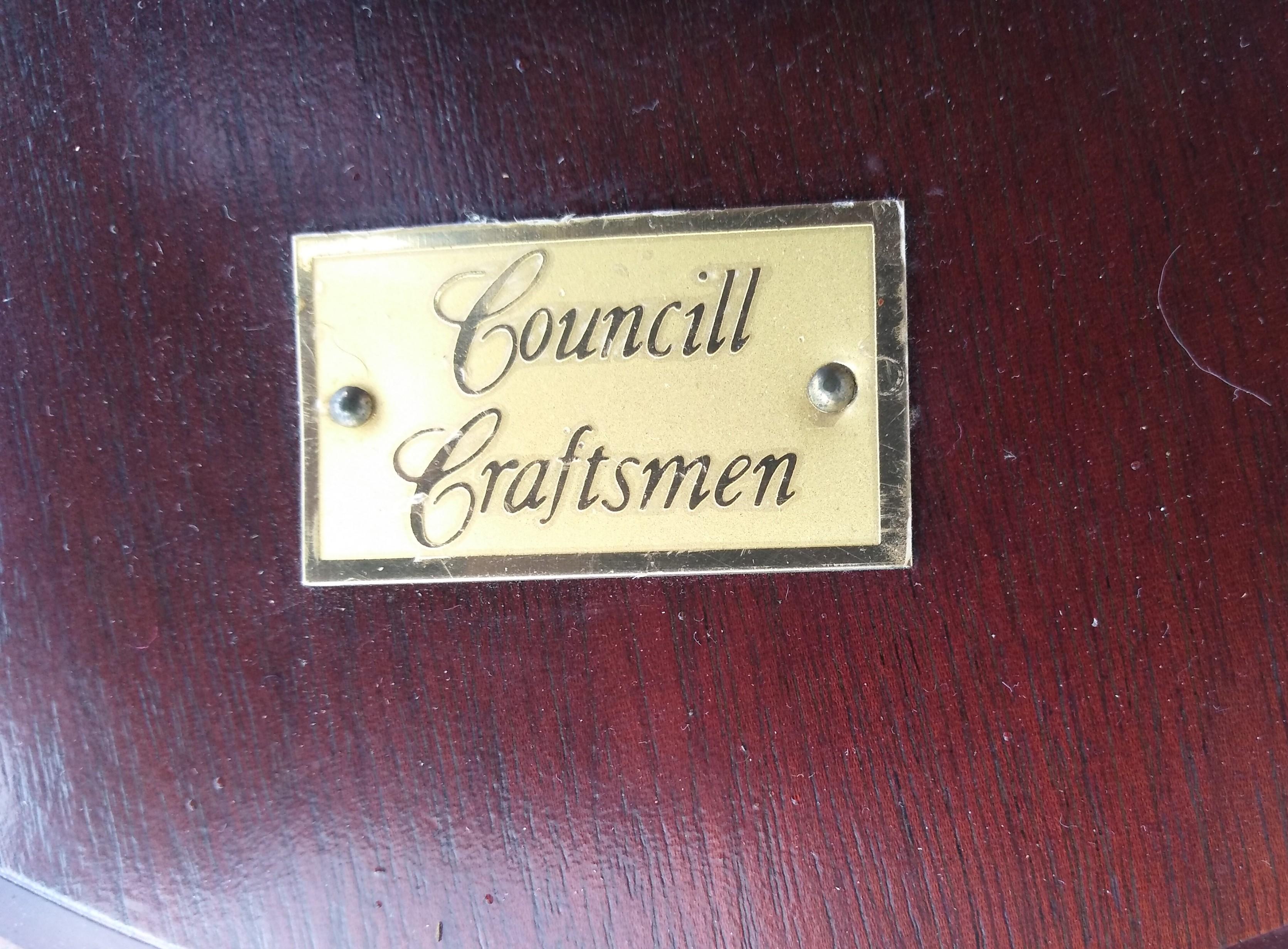 This is a nice quality price of furniture by Council Craftsman. It's made of mahogany with a ribbon mahogany band on top. It has brass caps on the feet that end in brass casters. 

A nice addition to your home.