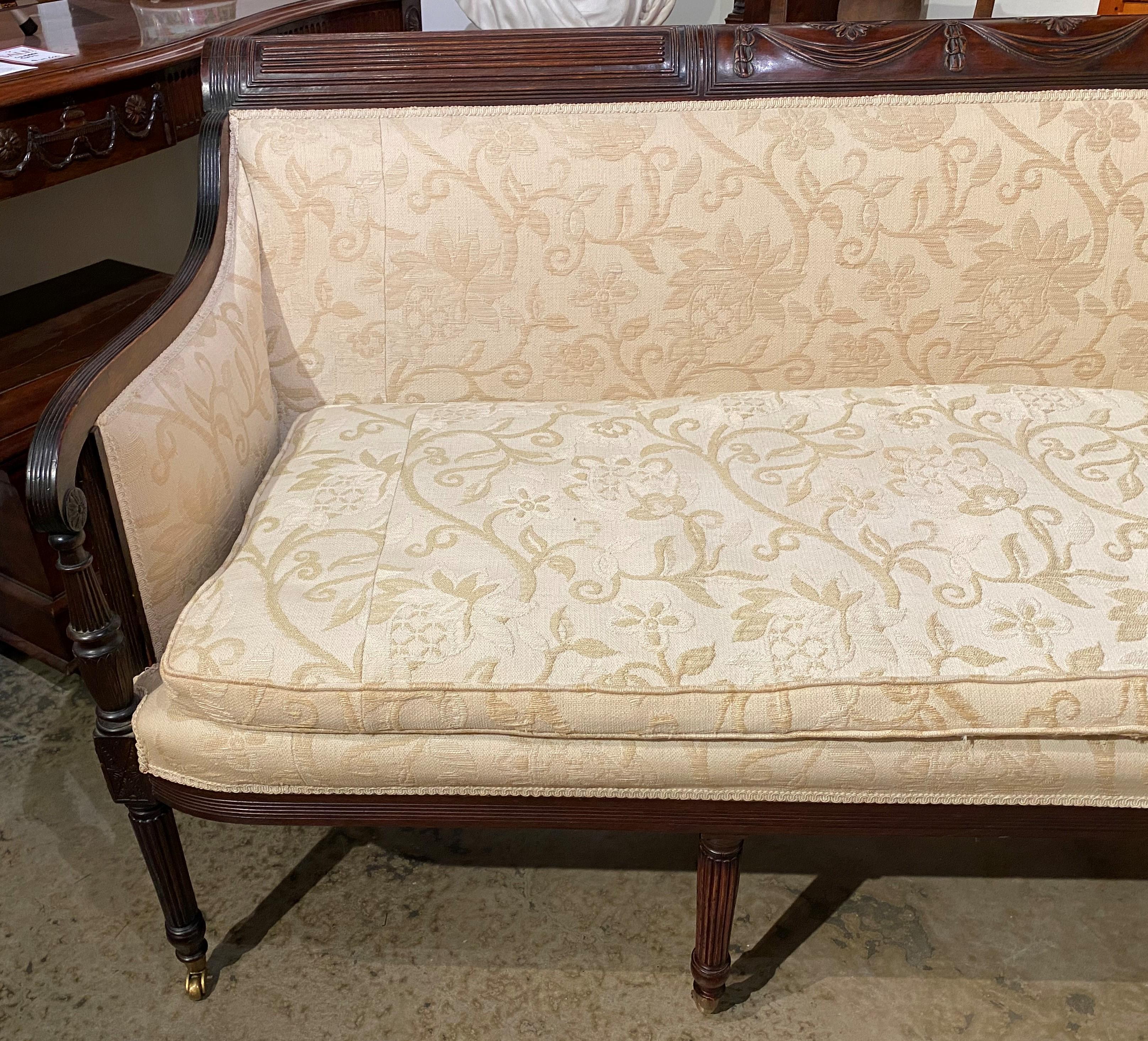 A fine Duncan Phyfe style Federal Mahogany Sofa with decorative swag carved crest, attributed to the Ernest F. Hagen (1830-1913) Workshop, with fine form scroll carved arms, foliate cream colored upholstery with removable cushion, all supported by
