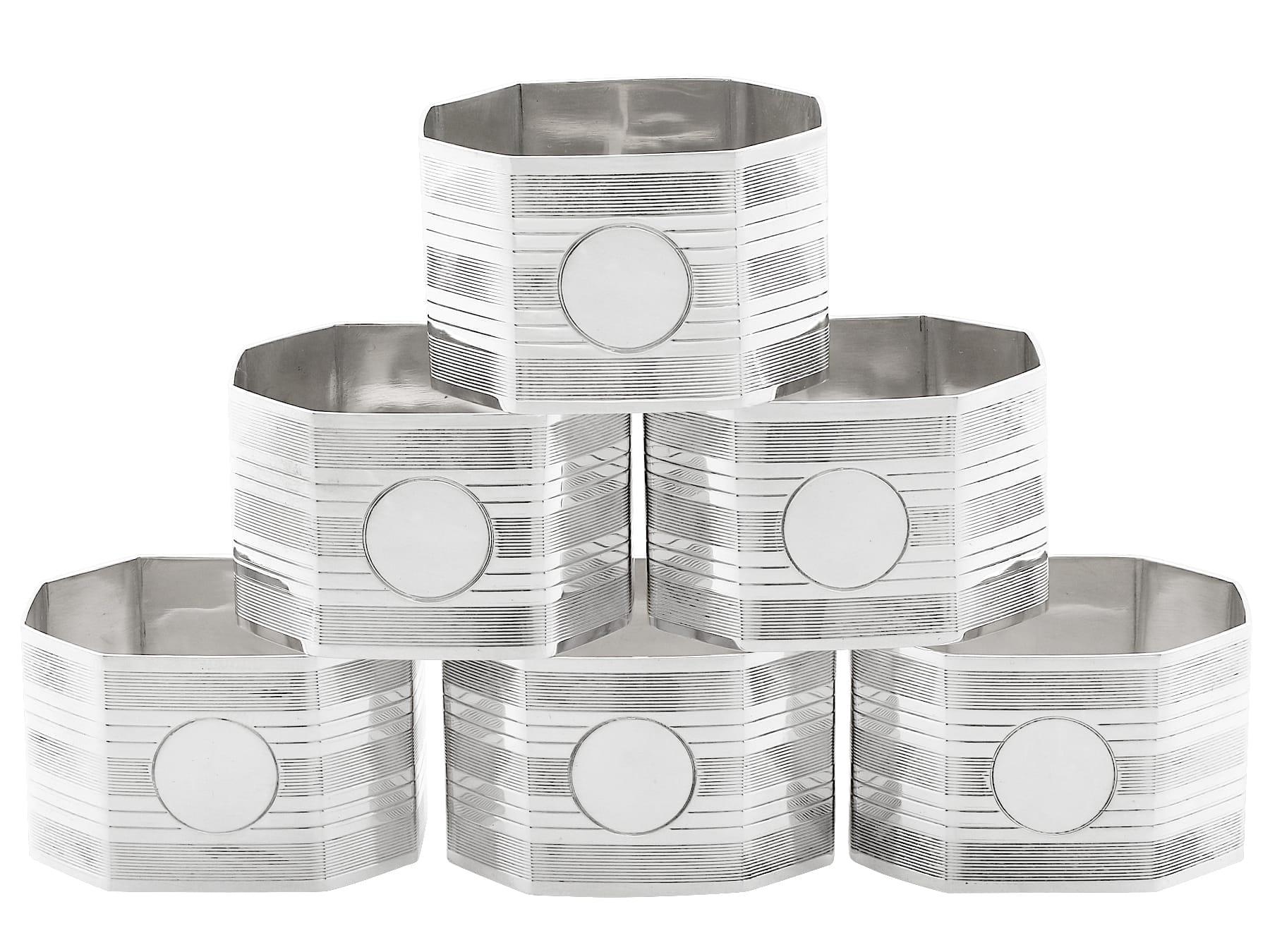 An exceptional, fine and impressive set of six antique George V English sterling silver napkin rings - boxed; an addition to our dining silverware collection.

This exceptional set of antique George V silver napkin rings consists of six napkin
