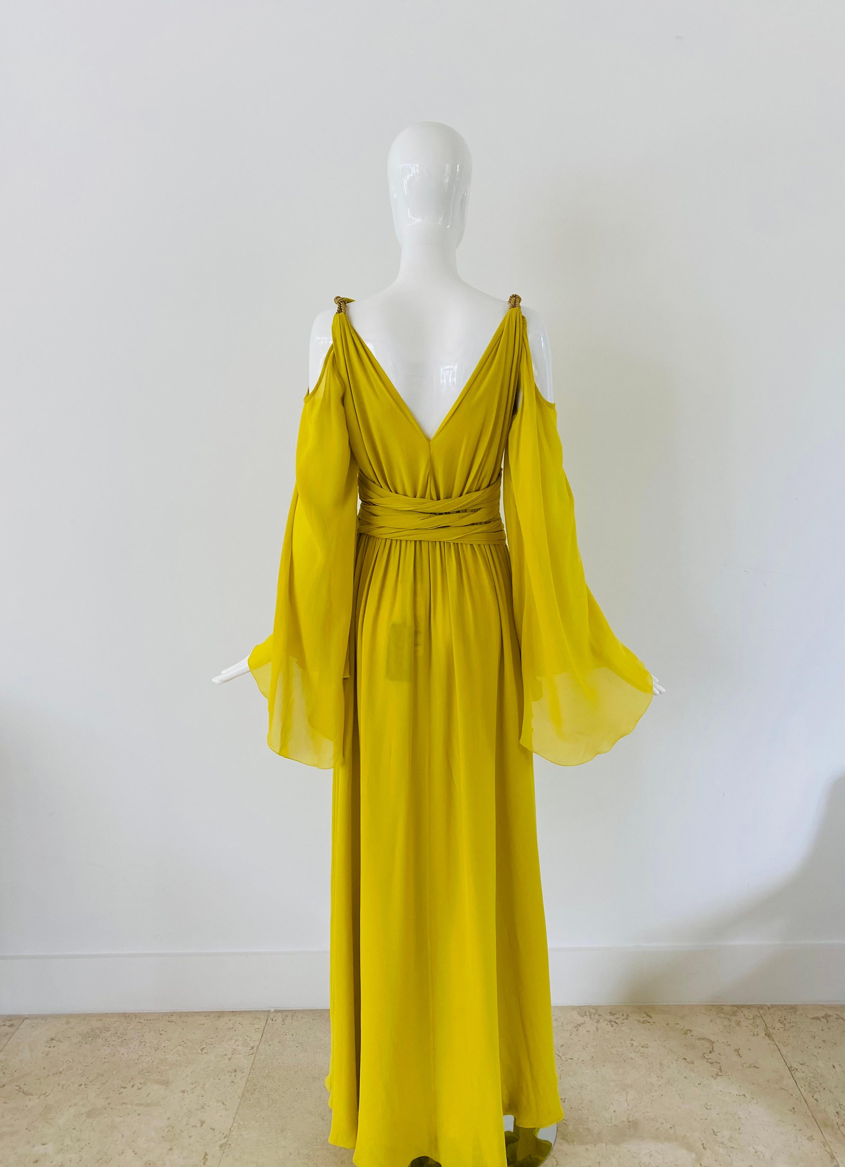 Modern gown by Peter Dundas' namesake label.  He has previously been the Creative Director for Pucci and Roberto Cavalli. He is known for his glamorous and feminine designs, and this long formal yellow silk gown is no exception. This dress is