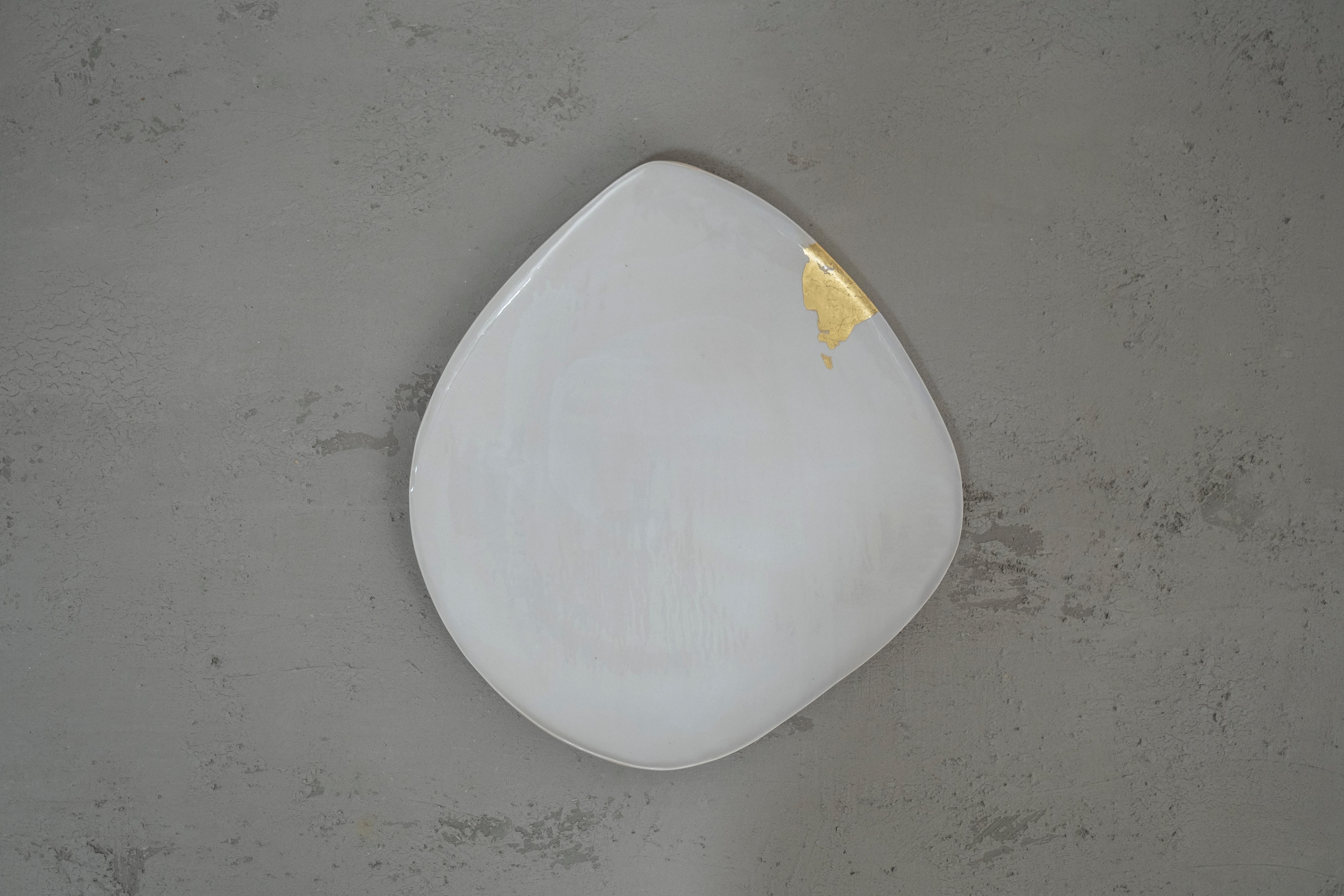 Dune #7 sculpture by Margaux Leycuras
One of a Kind, Signed and numbered
Dimensions: D 41 x H 45.5 cm.
Material: Sandy stoneware platter with white glaze and 22 Carat gold leaf.

The piece is signed, numbered and delivered with a certificate of