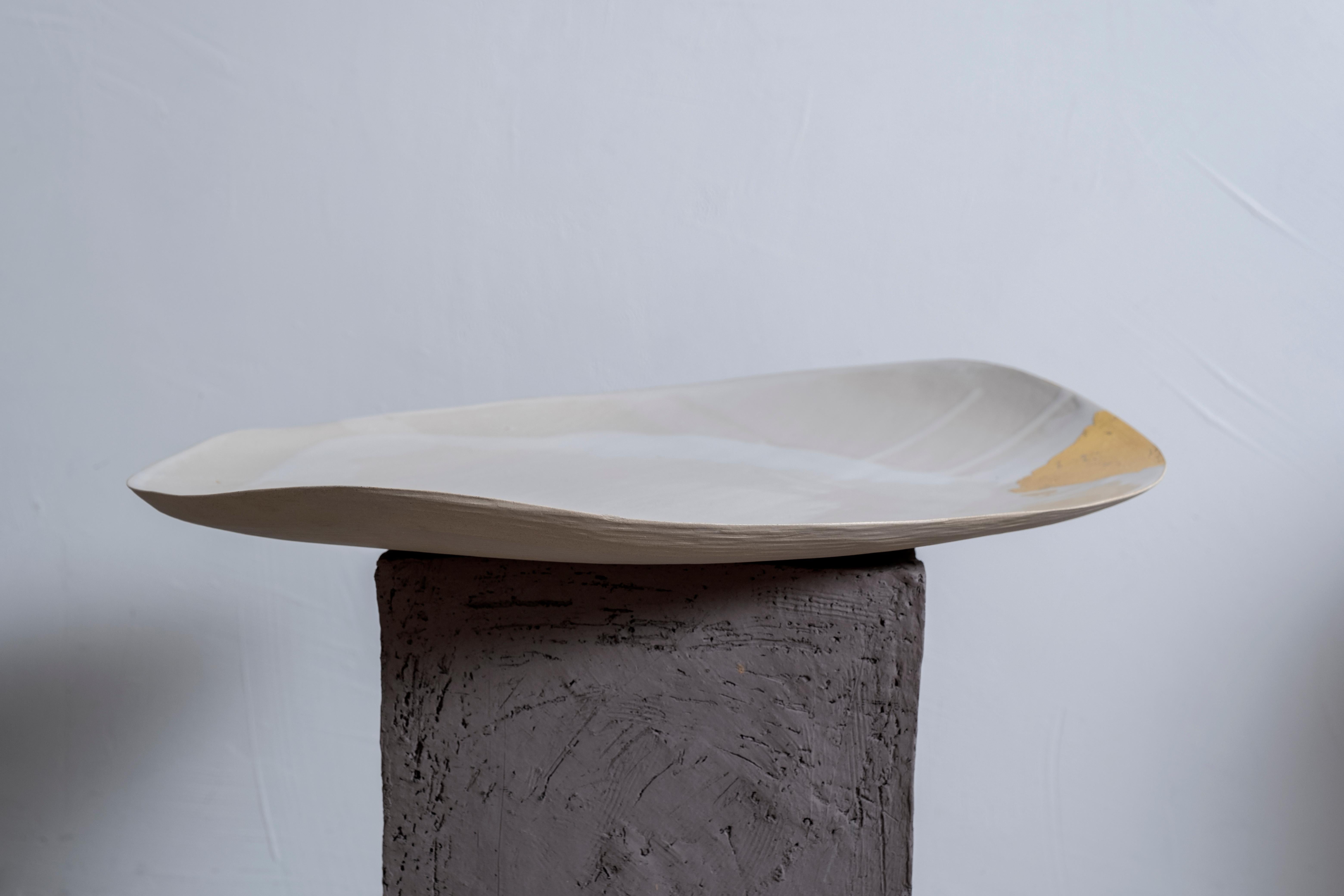Dune #9 sculpture by Margaux Leycuras
One of a Kind, Signed and numbered
Dimensions: D 38 x H 45 cm.
Material: Sandy stoneware platter with white glaze and 22 Carat gold leaf.

The piece is signed, numbered and delivered with a certificate of