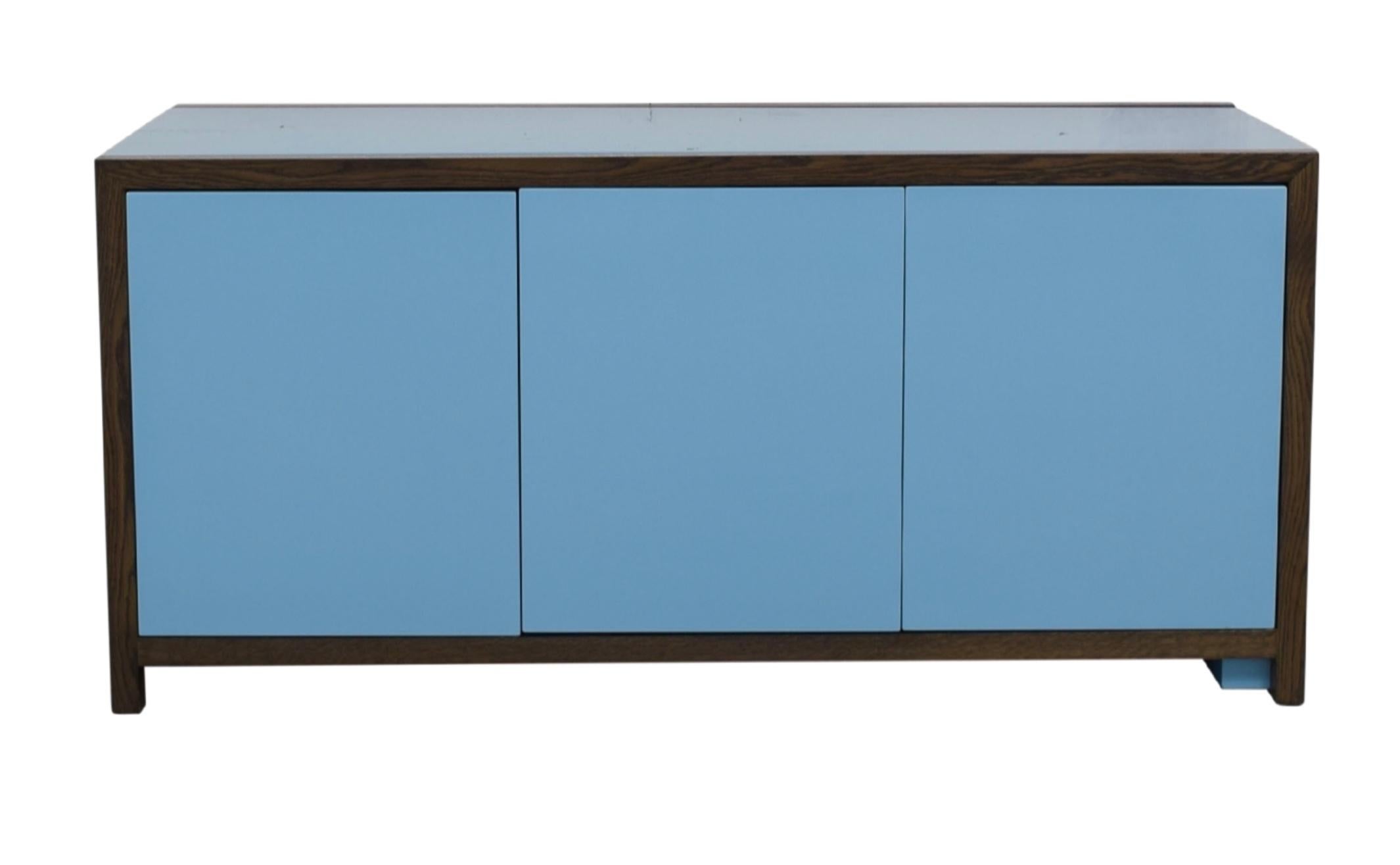 Dune New York Lemans (2000) cabinet/desk in plastic laminate, wood veneer, hi-gloss poly-urethane. Solid wood frame and legs. Top slides to create worksurface. Interior composed of: right door contains one file drawer and two smaller drawers. Center