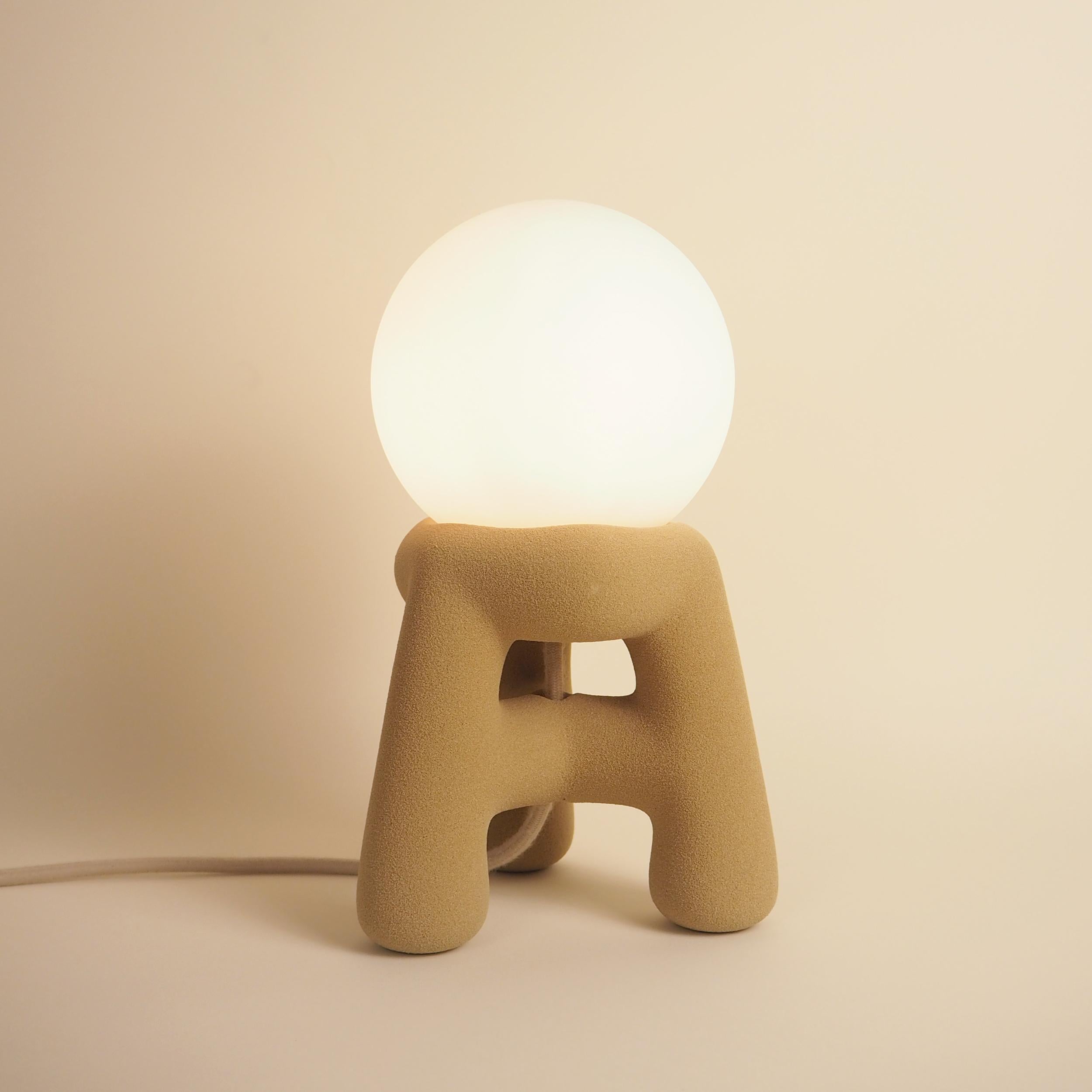 Dune Table Lamp by Luis Gimeno
Dimensions: D 17 x W 17 x H 29 cm
Materials: Quartz sand.

Available in beige, pink, or black colors. Please contact us.

This three legged lamp is made using the latest 3D printing technology and sand as the material,