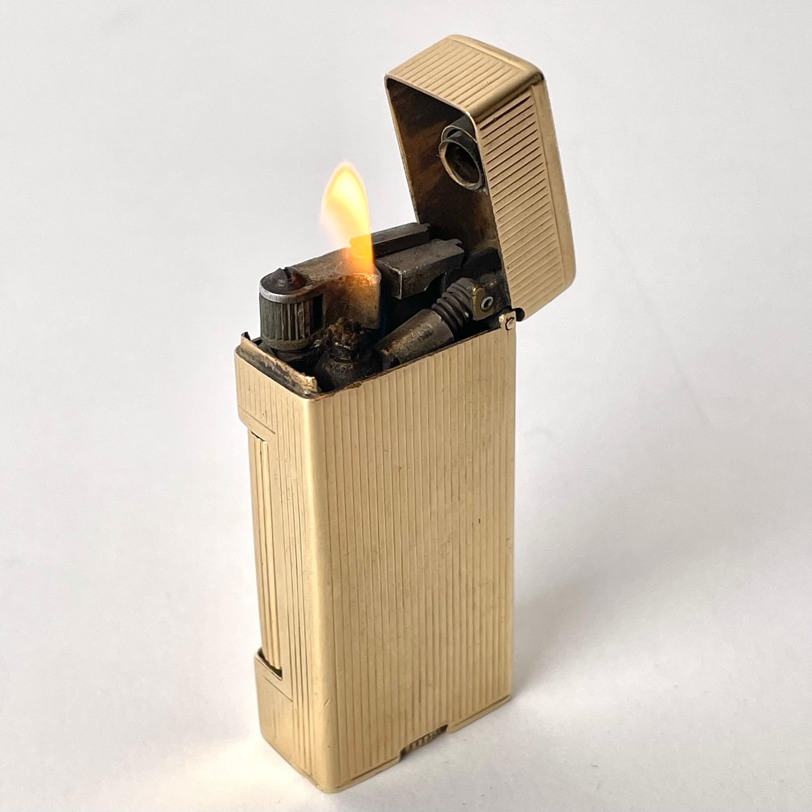 An Elegant 14 Carat Gold Cigarette Lighter, Gasoline Petrol, Albert Dunhill,  probably made during the 1940s or 1950s

The perfect accessory for any gentleman or lady looking to make their smoking habit even more glamorous by adding a luxury 14