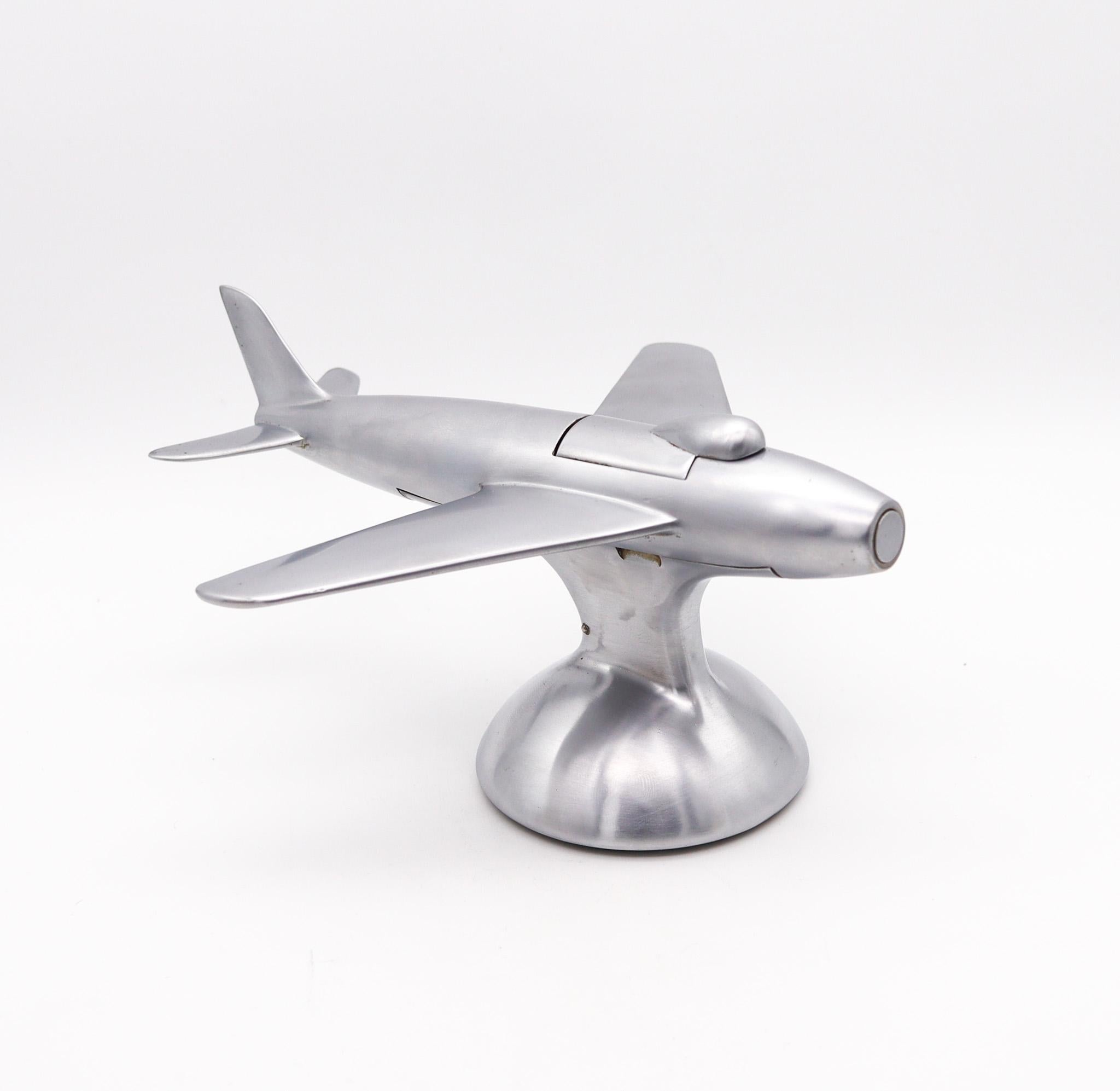 F-86 Jet fighter aircraft table lighter designed by Alfred Dunhill.

Very rare brushed aluminum table desk lighter made in London England by the renowned Alfred Dunhill Company, between 1954 and 1961. The lighter was done in the Mid-Century Modern