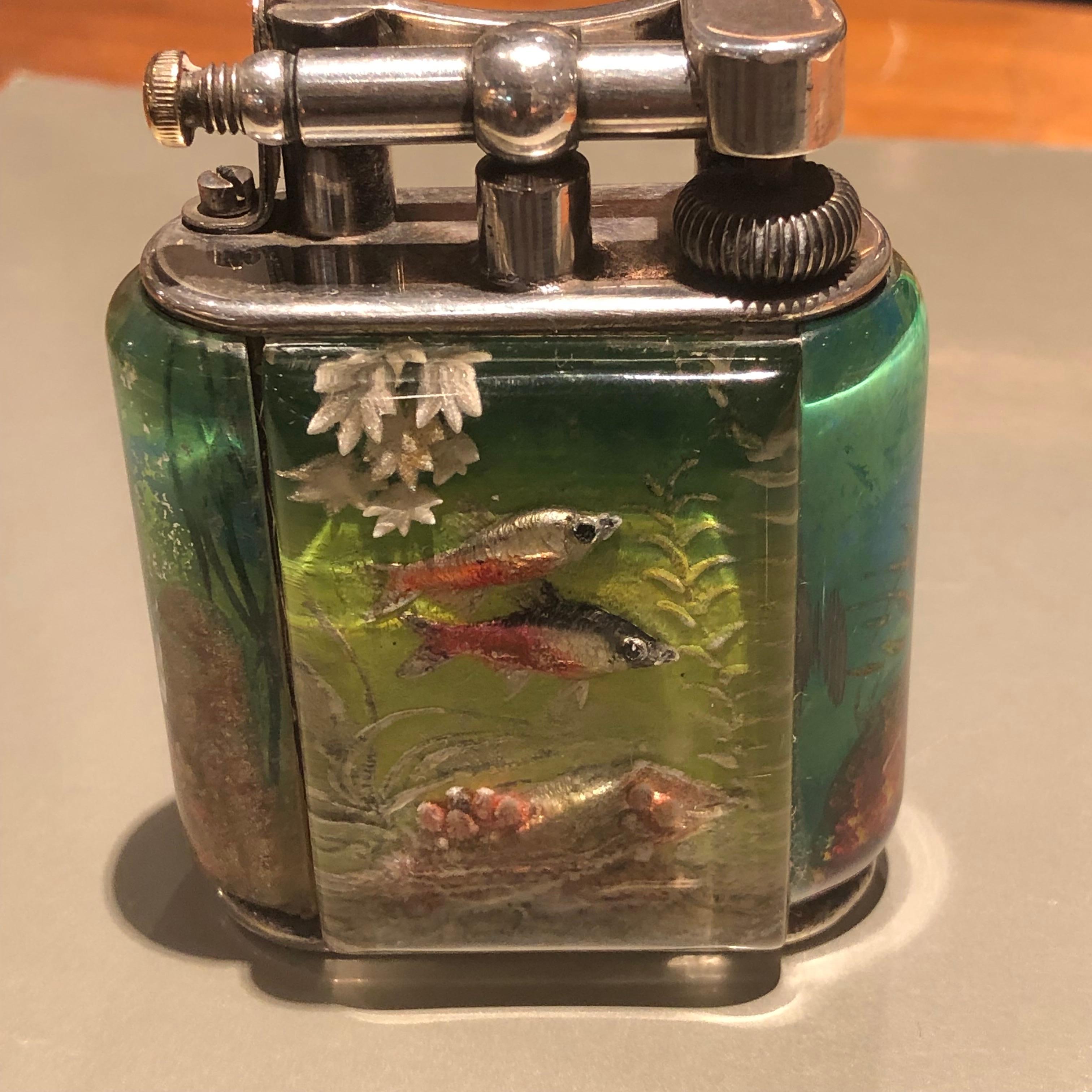 One of the most iconic lighters from Dunhill. The aquarium lighter has garnered an extraordinary reputation as one of the most unique luxury items to own.

Ben Shillingford (1904-2000) worked for Dunhill in the 1950s and perfected the art of