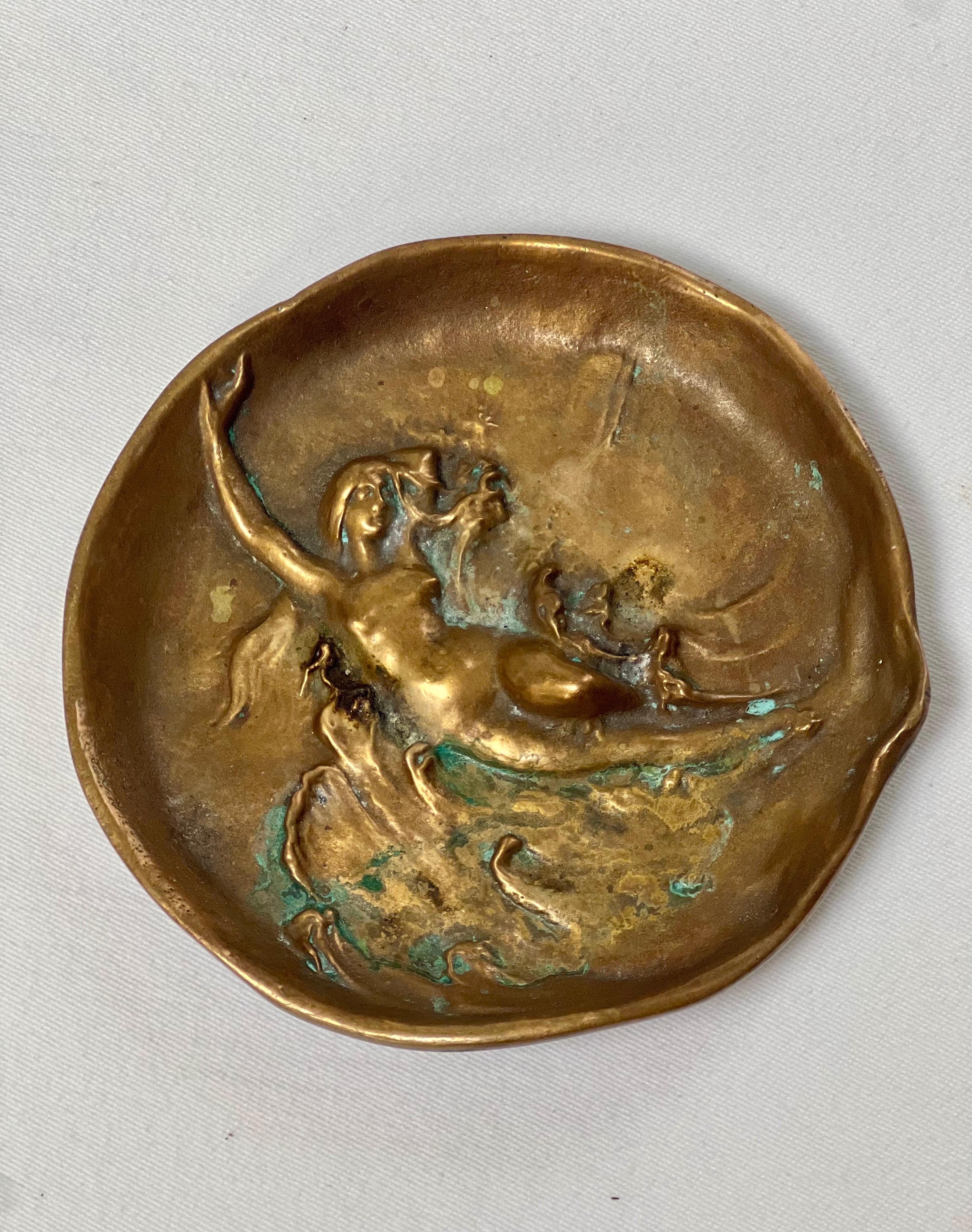 Rare pair of English Dunhill art nouveau patinated bronze ashtrays, catchalls with a female nude amongst waves in bas relief with organic form edge, London, England, early 20th century.  Marked Dunhill on the underside.  

4 7/8