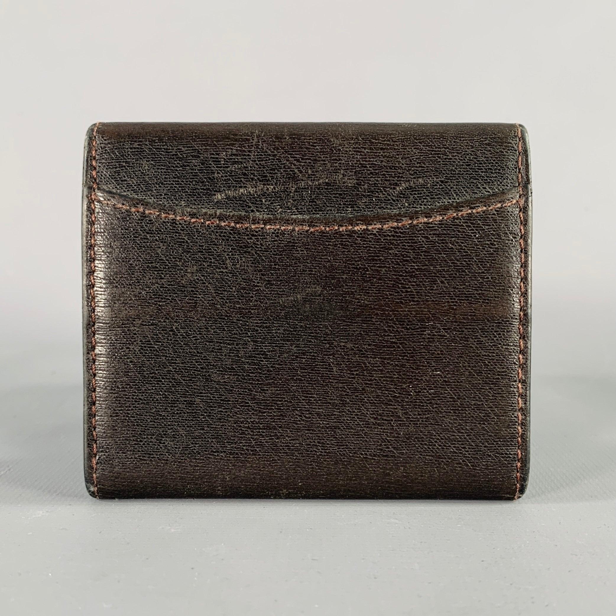 DUNHILL wallet
in a brown leather featuring silver tone metal logo and textured stitching details.Excellent Pre-Owned Condition.3.5 X 3 inches 
  
  
 
Sui Generis Reference: 136099
Category: Wallet
More Details
    
Brand:  DUNHILL
Color: 