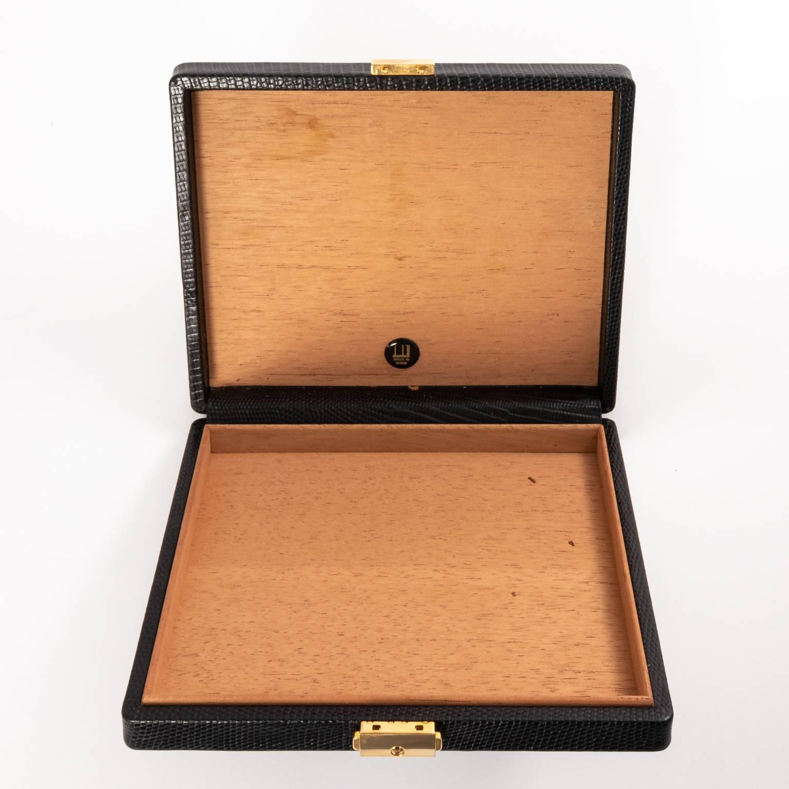 Dunhill travel cigar case in black leather with gold clasp, circa 1980s.
 