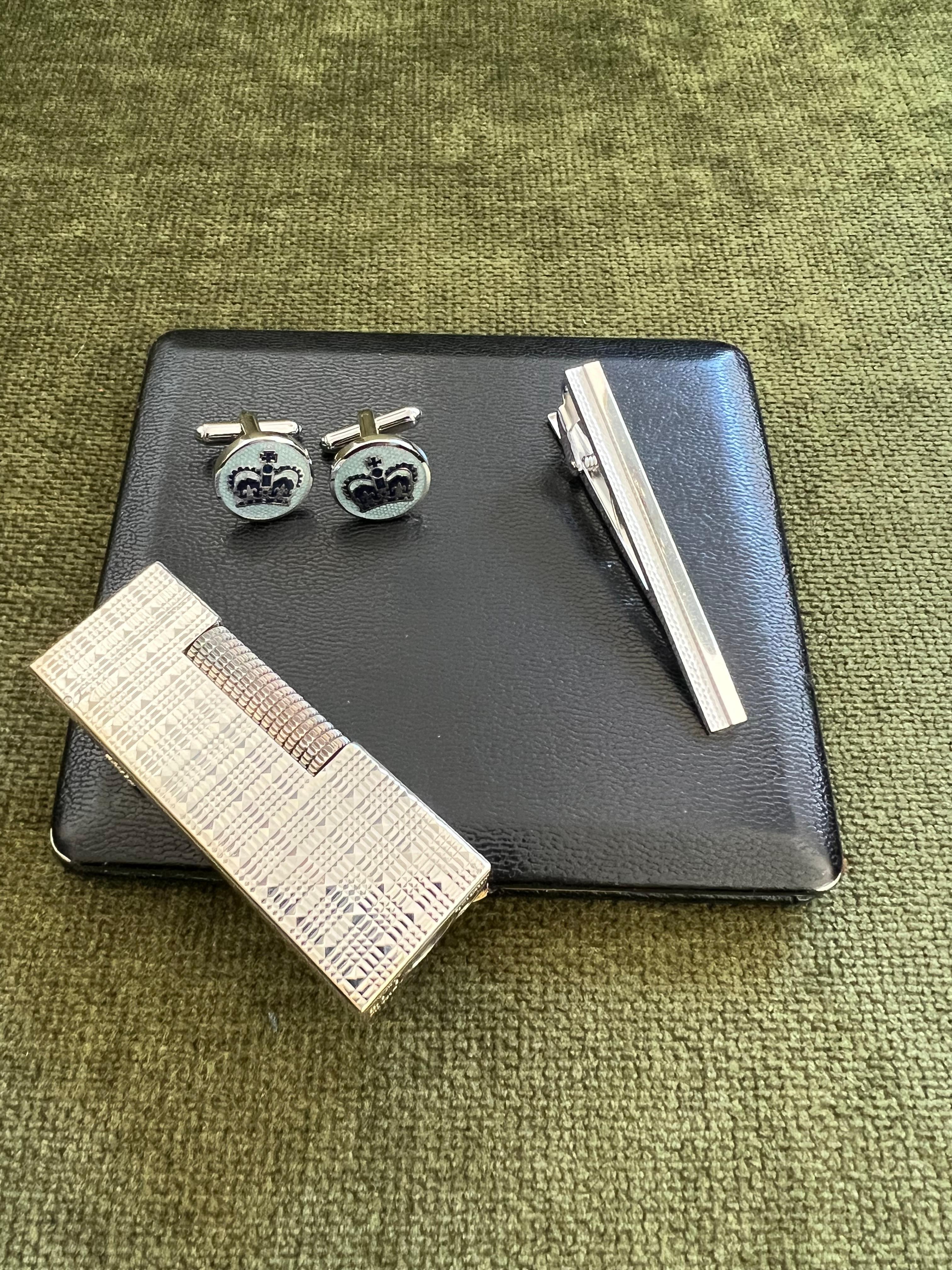 Vintage Dunhill Cigarette Case & Lighter, Katharine Hamnett Tie Clip & Cufflinks Set 

Elegant Vintage Dunhill Cigarette case, British lather 
Vintage Silver Dunhill Lighter 
Signed Alfred Dunhill
Circa 1960s

Synonymous with British craftsmanship