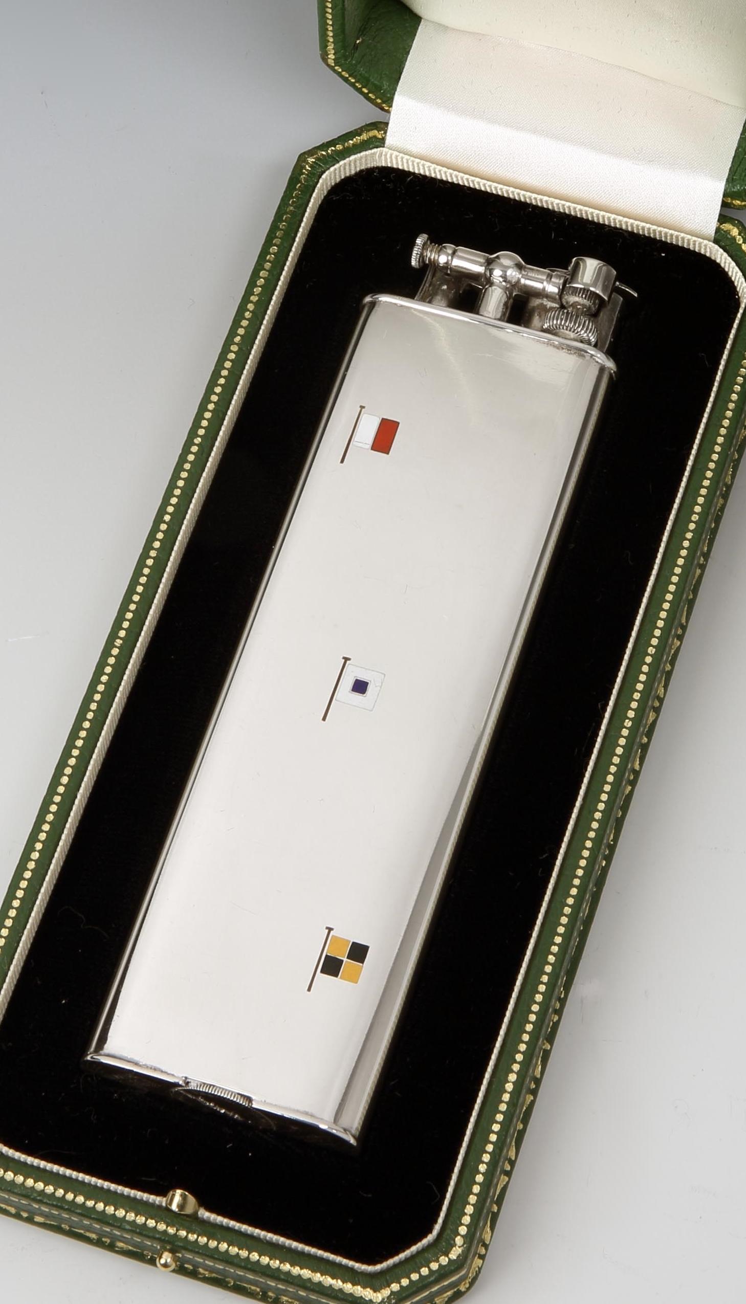 Alfred Dunhill for Cartier, Paris

A sterling silver 'Unique Sports' lighter, the result of a collaboration between Dunhill and Cartier, Paris, the lift arm marked Dunhill, the base marked Cartier, Swiss made, and sterling. The front of the