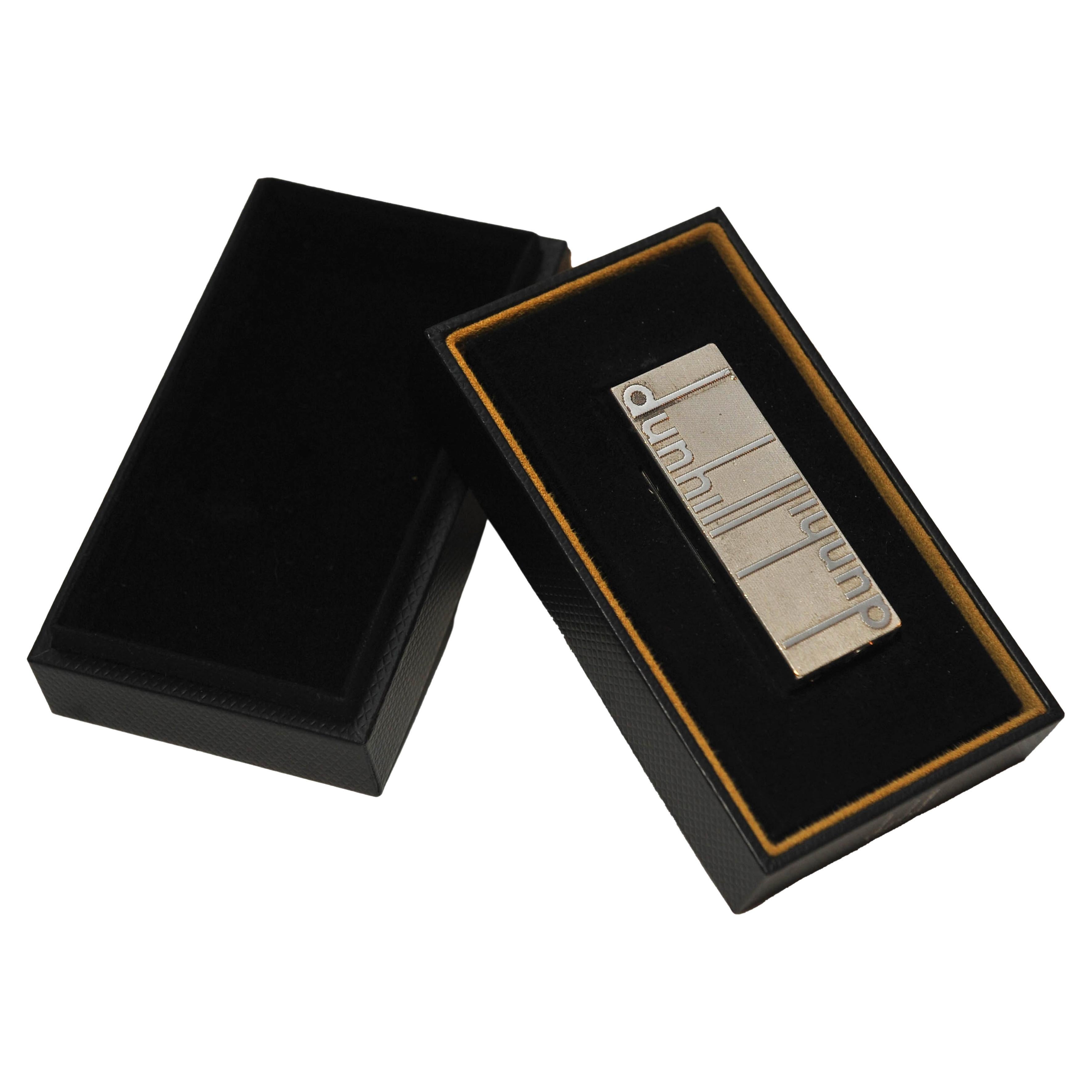 Dunhill of London Longtail Logo Rollgas Cigarette Lighter With Guarantee Card and Original Dunhill Presentation Box Box 

Inspired by the dunhill archive, a palladium-plated brass lighter featuring the iconic longtail logo.

Made in Switzerland