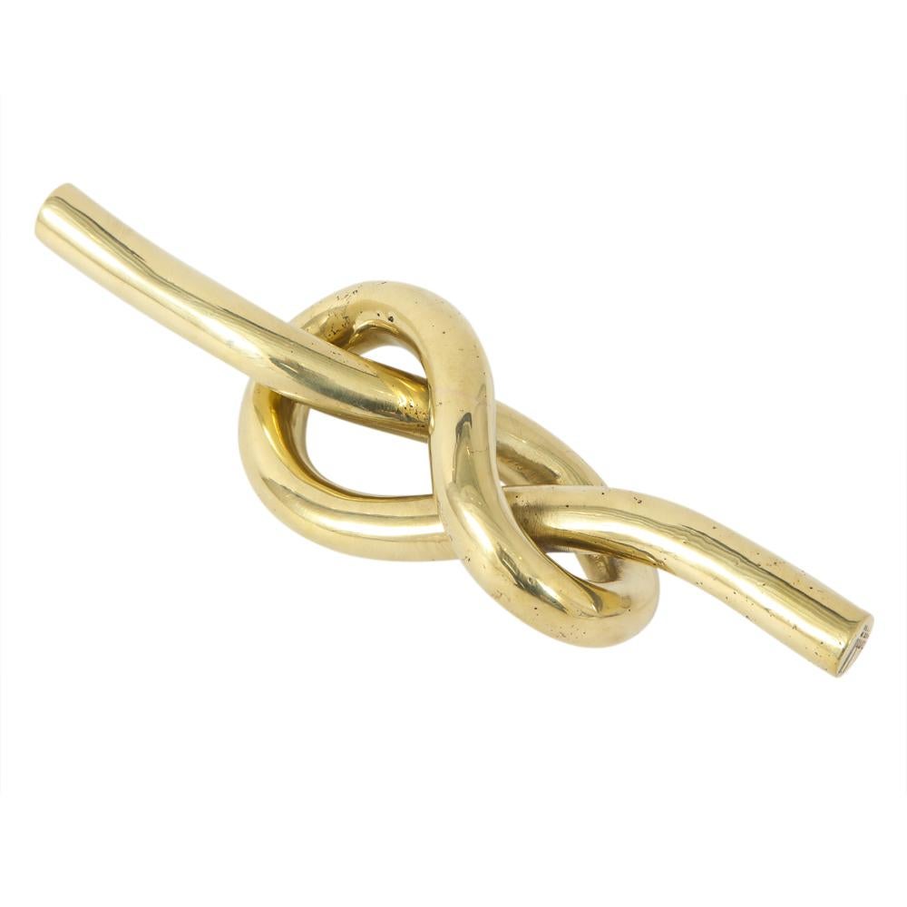 Dunhill paperweight, brass knot, signed. Chunky tubular brass knot paperweight with figure eight design and composed of 1/2