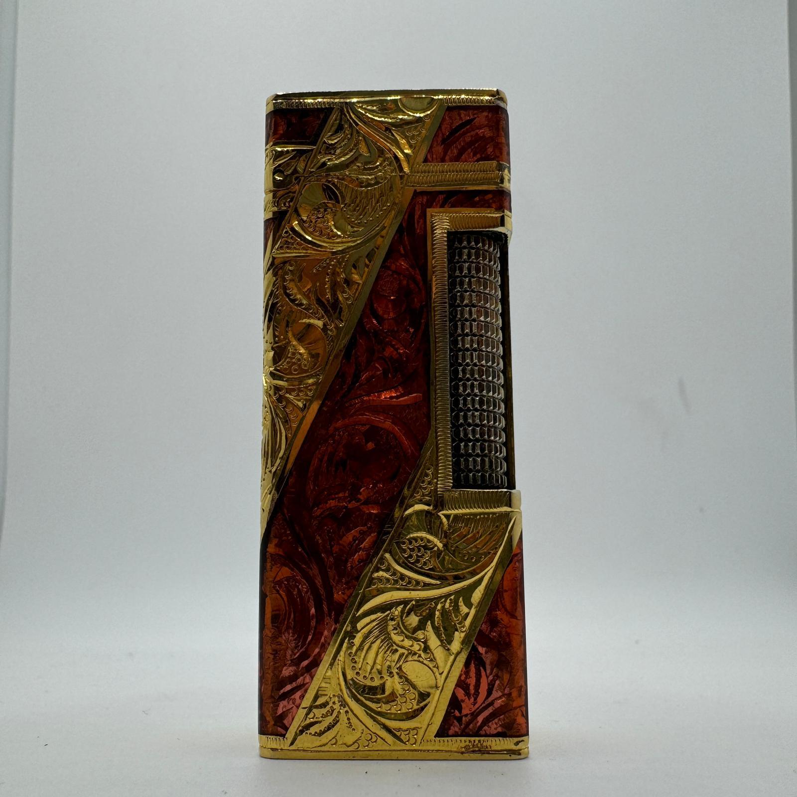 Dunhill Rare Royking Lighter, 18k Gold Plating & Enamel Inlay  “Royking” lighter.
Circe 1980
Roy King Rollagas, a Unique RARE example of a ROYKING designed lighter made circa 1970's, 18K Gold Baroque Inlay with, Red, Blue lacquer, mint