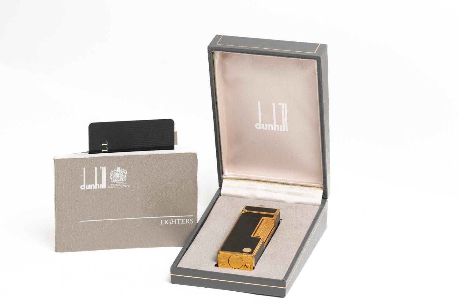 Fantastic vintage gold-plated Dunhill lighter with very elegant and luxurious Chinese black lacquer. The lighter is in good vintage condition and comes with an original box, Dunhill's service card and an original book. The lighter is stamped on the