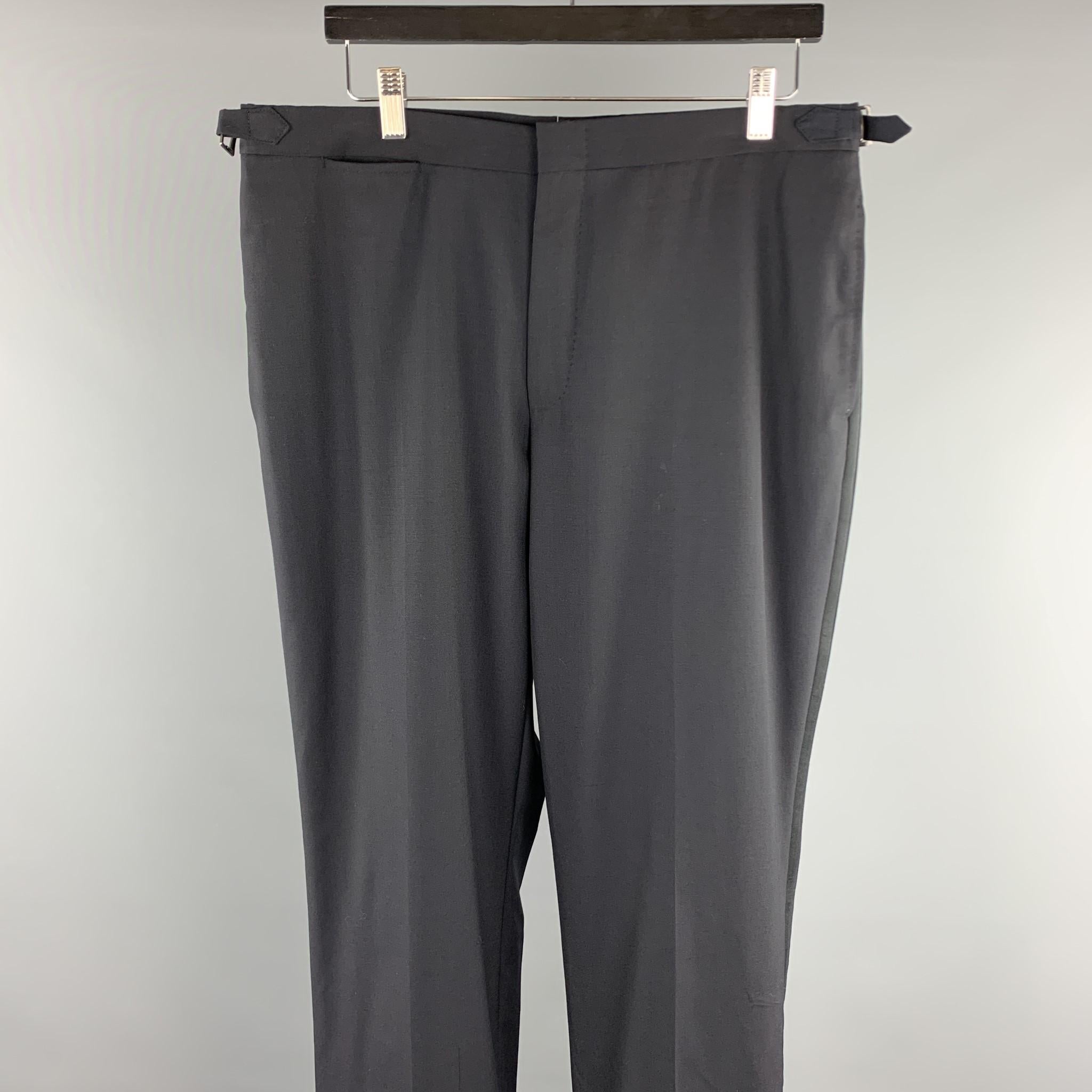 DUNHILL dress pants comes in a black wool featuring a tuxedo style, side tabs, and a zip fly closure. 

Excellent Pre-Owned Condition.
Marked: ( No Sized Marked )

Measurements:

Waist: 34 in.
Rise: 10 in. 
Inseam: 32 in.