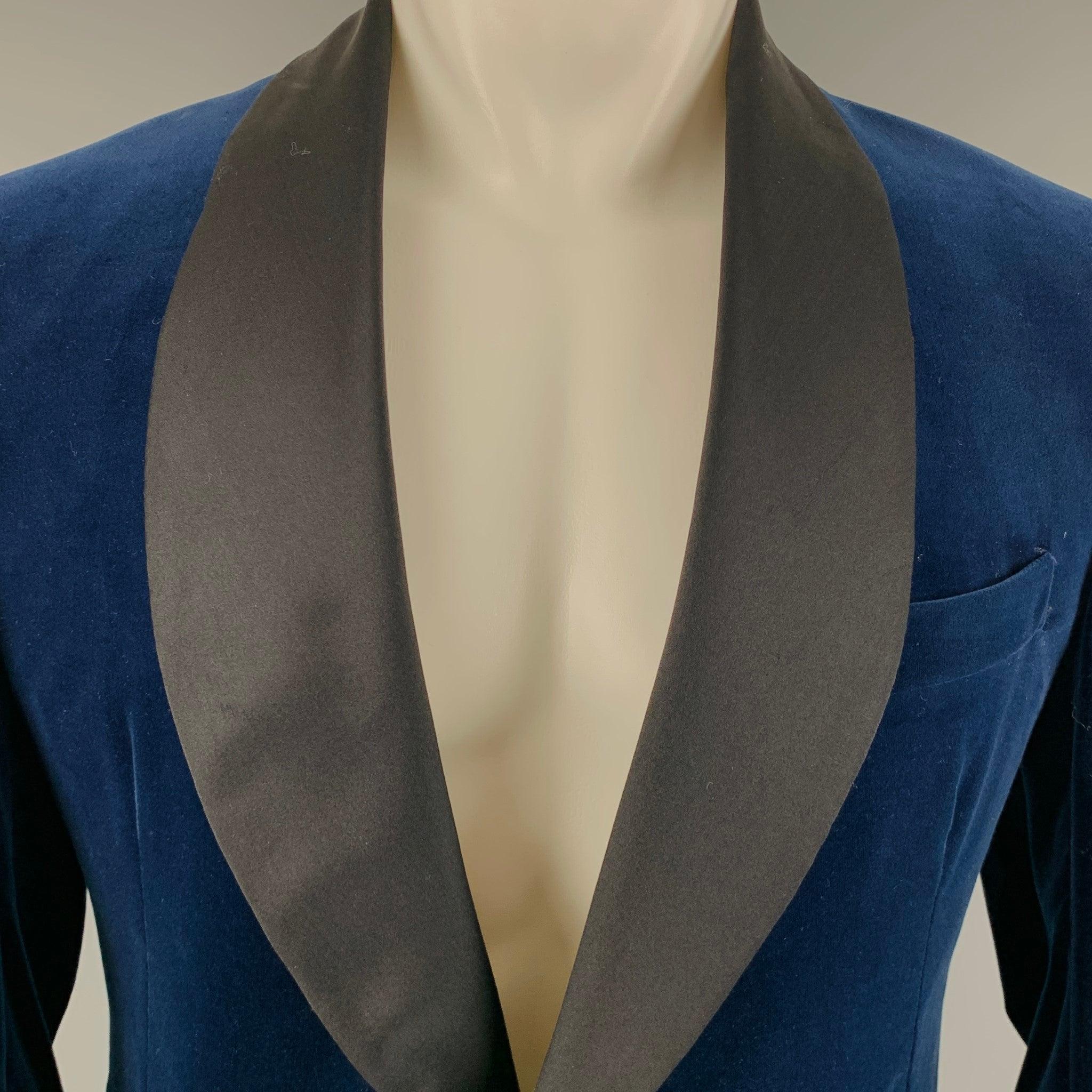 Vintage1968 DUNHILL sport coat
in a blue velvet fabric featuring shawl collar, ventless back, and single button closure.Very Good Pre-Owned Condition. Minor signs of wear on collar. 

Marked:   SP06466 

Measurements: 
 
Shoulder: 18 inches Chest: