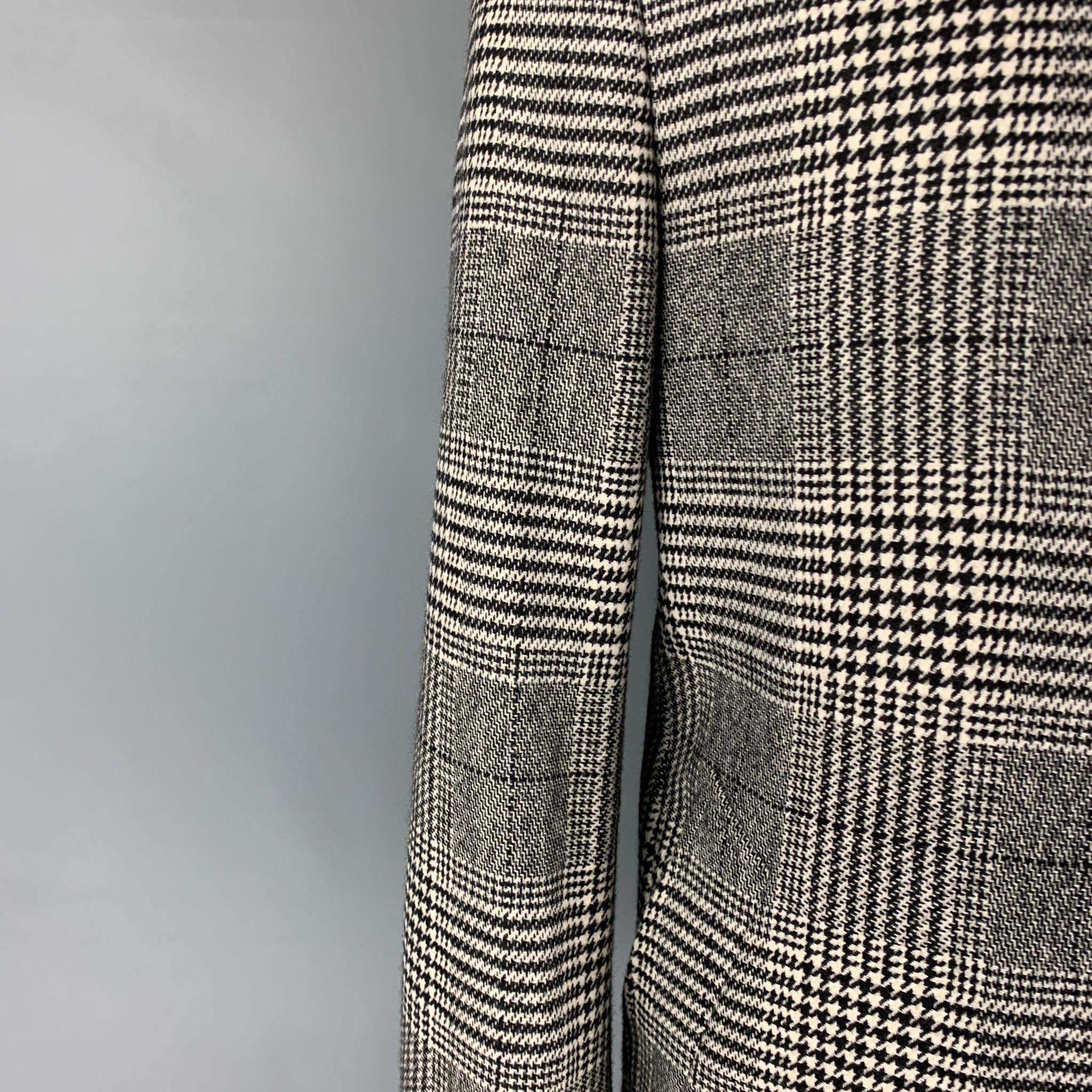 DUNHILL coat comes in a black & white plaid wool / cashmere with a half liner featuring a spread collar, slit pockets, single back vent, buttoned cuffs, and a buttoned closure. Made in Italy. 

Excellent Pre-Owned Condition.
Marked: