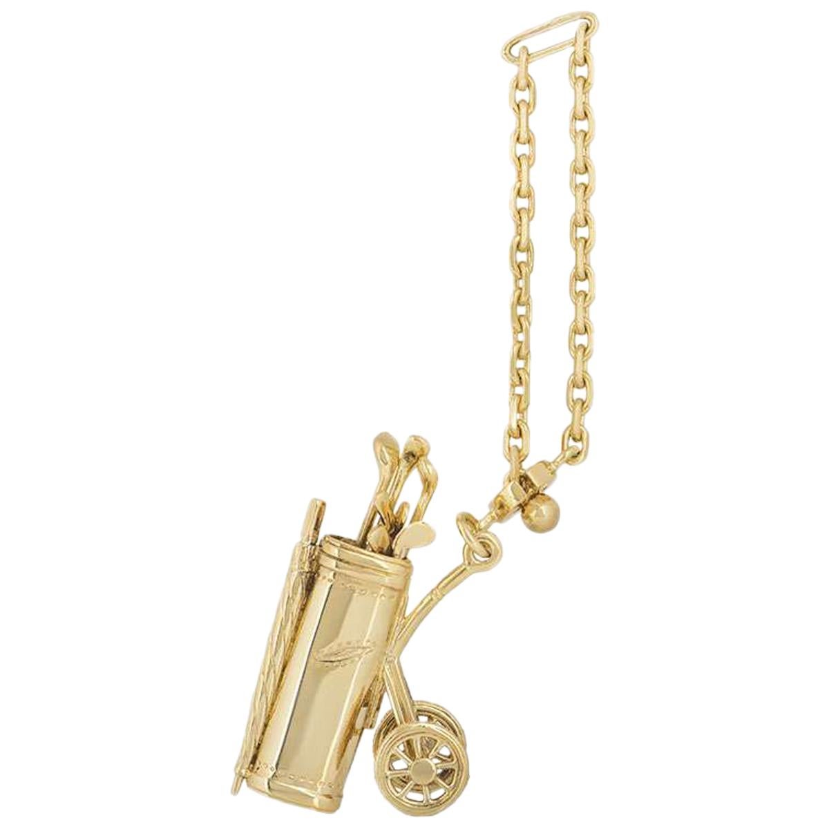 A yellow gold golf trolly key chain by Dunhill. The golf trolly is complete with 7 golf clubs, spinning wheels and a hanging chain. The key chain has a high polished finish and measures 4cm in height, with a gross weight of 19.5 grams.

The key