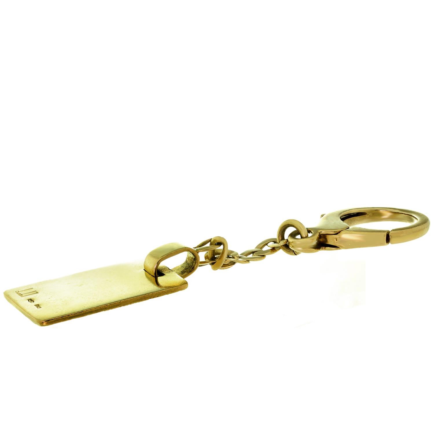 This classic Dunhill keychain features a textured rectangular design crafted in 18k yellow gold. Made in Italy circa 1990s. Measurements: 3.11