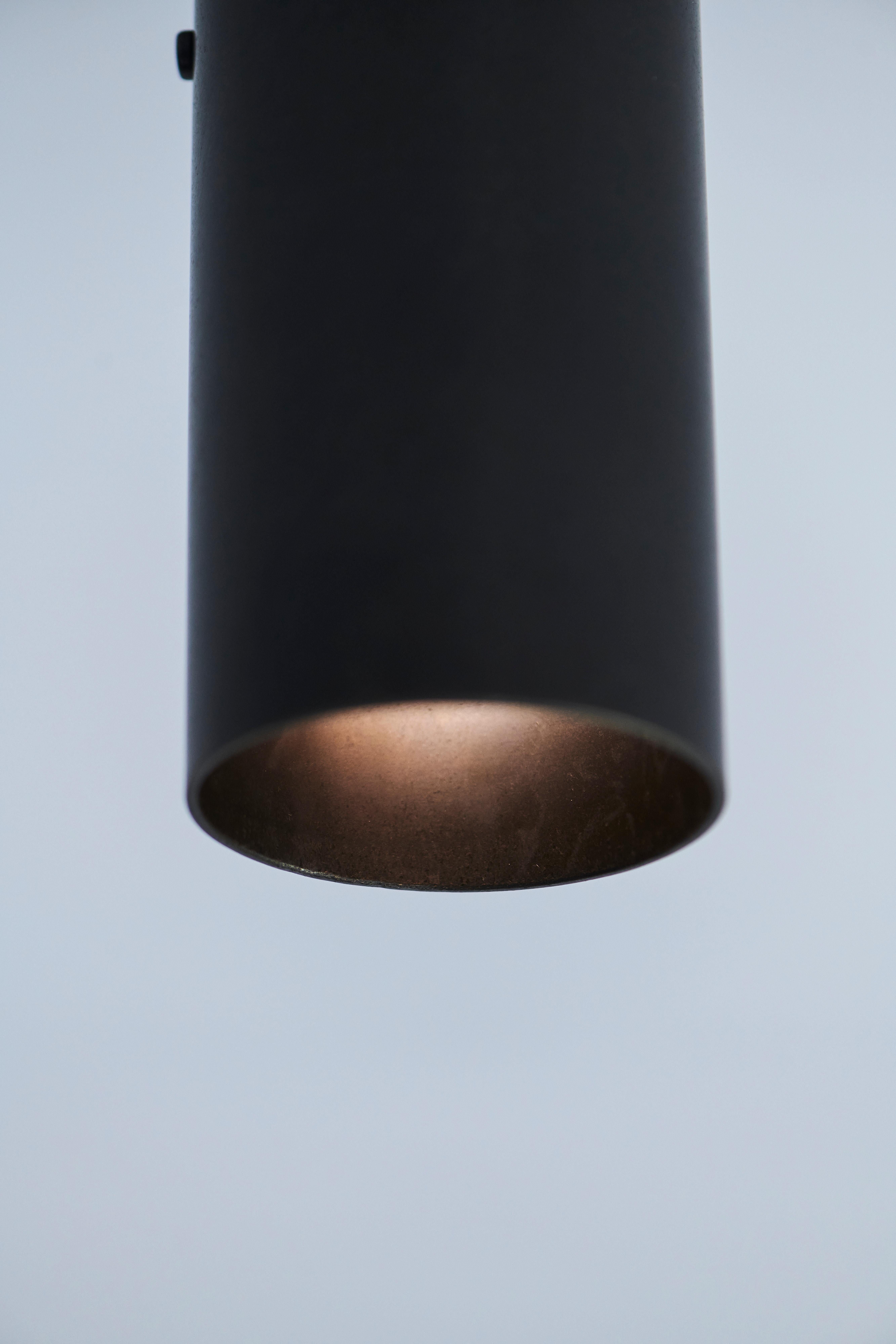 Handmade in solid brass in Australia by Dunlin. 

A heavyweight, solid brass pivoting spotlight. 
A cast brass ball pivot allows the light to rotate around its stem. 

14.5 cm long x 6.3 cm dia
(5.7