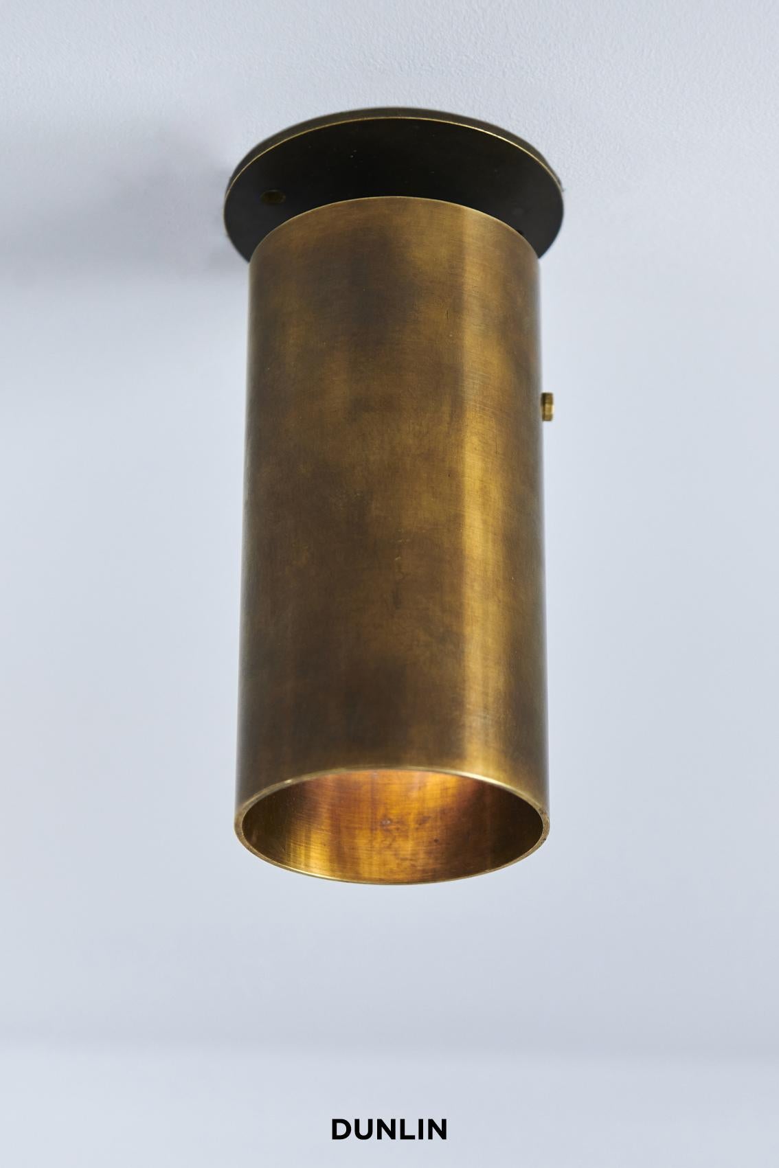 Handmade in solid brass in Australia by Dunlin. 

A heavyweight, solid brass pivoting spotlight. 
A cast brass ball pivot allows the light to rotate around its stem. 

14.5 cm long x 6.3 cm dia
Finish: Tarnished Raw Brass

Available in Noir or