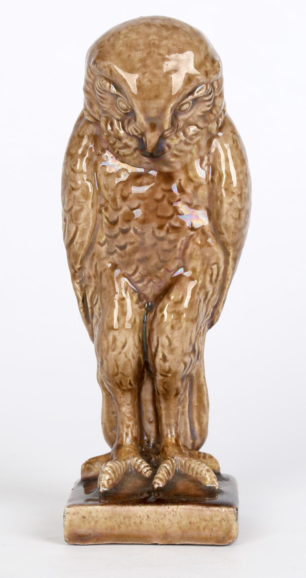 A rare and unusual Arts & Crafts Dunmore attributed art pottery figure of an owl dating from around 1900. The owl stands perched on a small rectangular base and is well detailed and potted with large talons and incised feather patterning and good