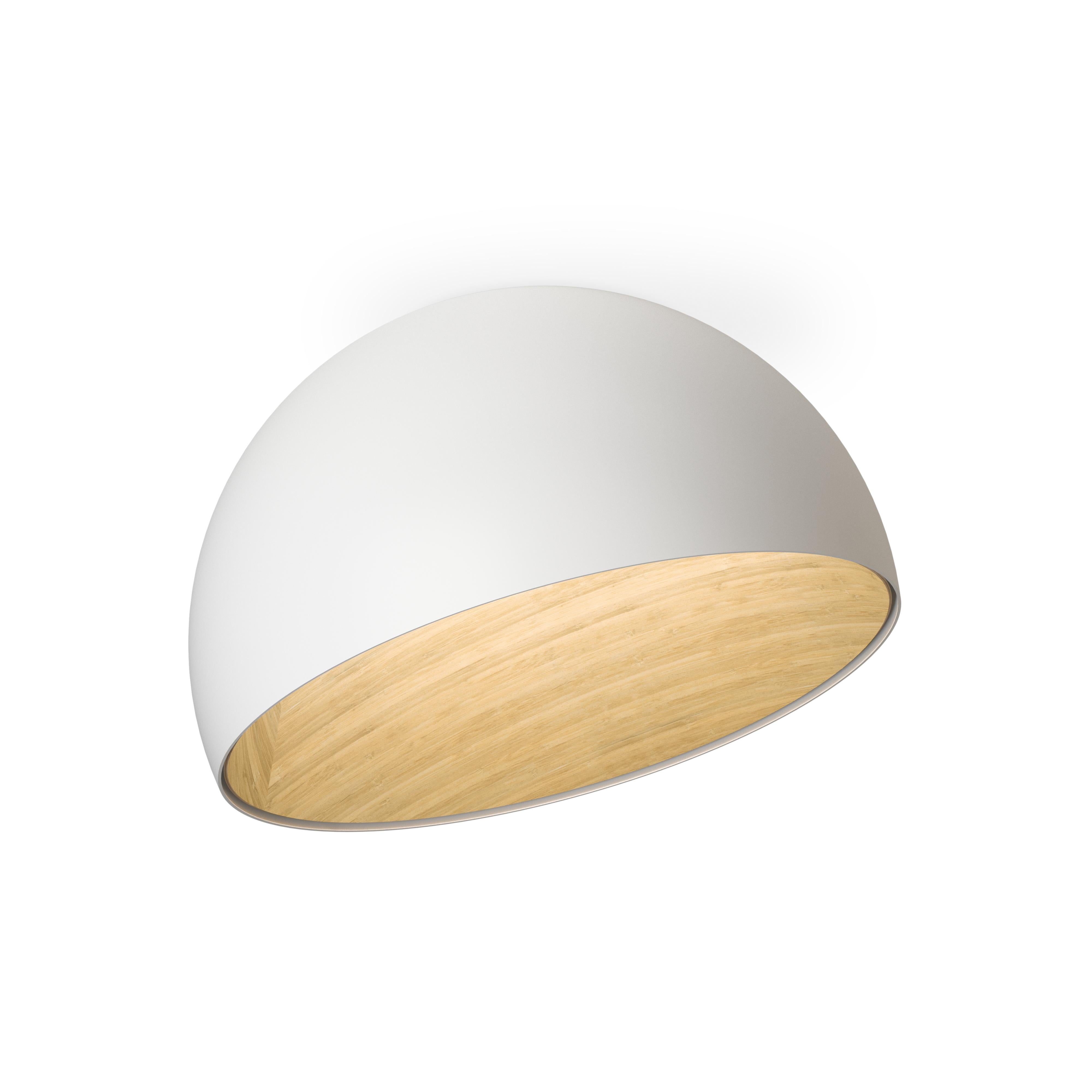 The collection DUO is inspired by sustainability and wellness. This flush-mount surface light is designed for places with a lower ceiling. The inner surface of the shade is lined with oak veneer, enveloped in a matte lacquered outer shell