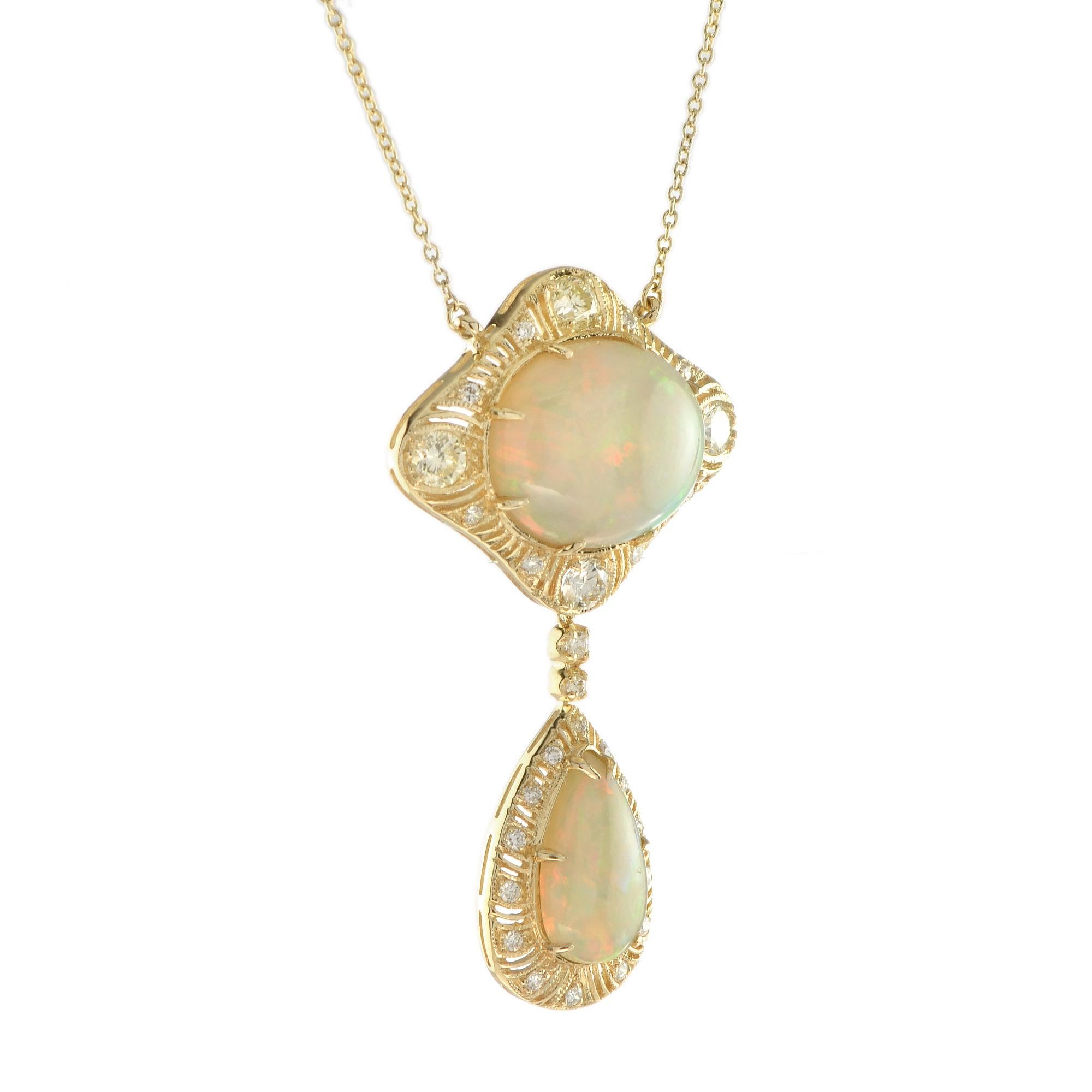 A beautiful antique inspired 18k gold pendant necklace, featuring a pear and an oval shaped  yellow-green to reddish orange cabochon opal. They are surrounded in the frame by total of 28 H/SI round cut diamonds. A wonderful addition to any