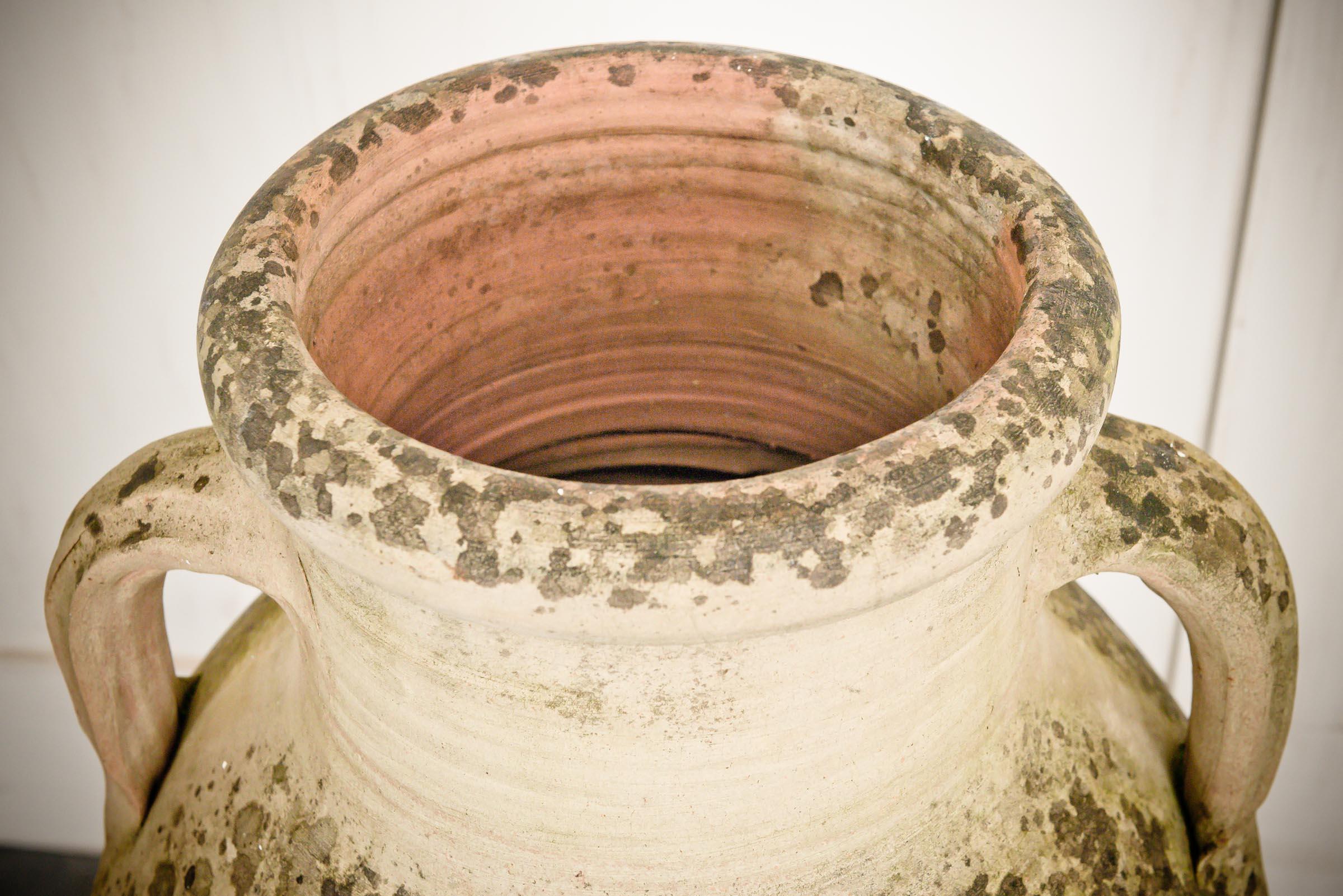 Duo of greek weathered garden urns made from terracotta.