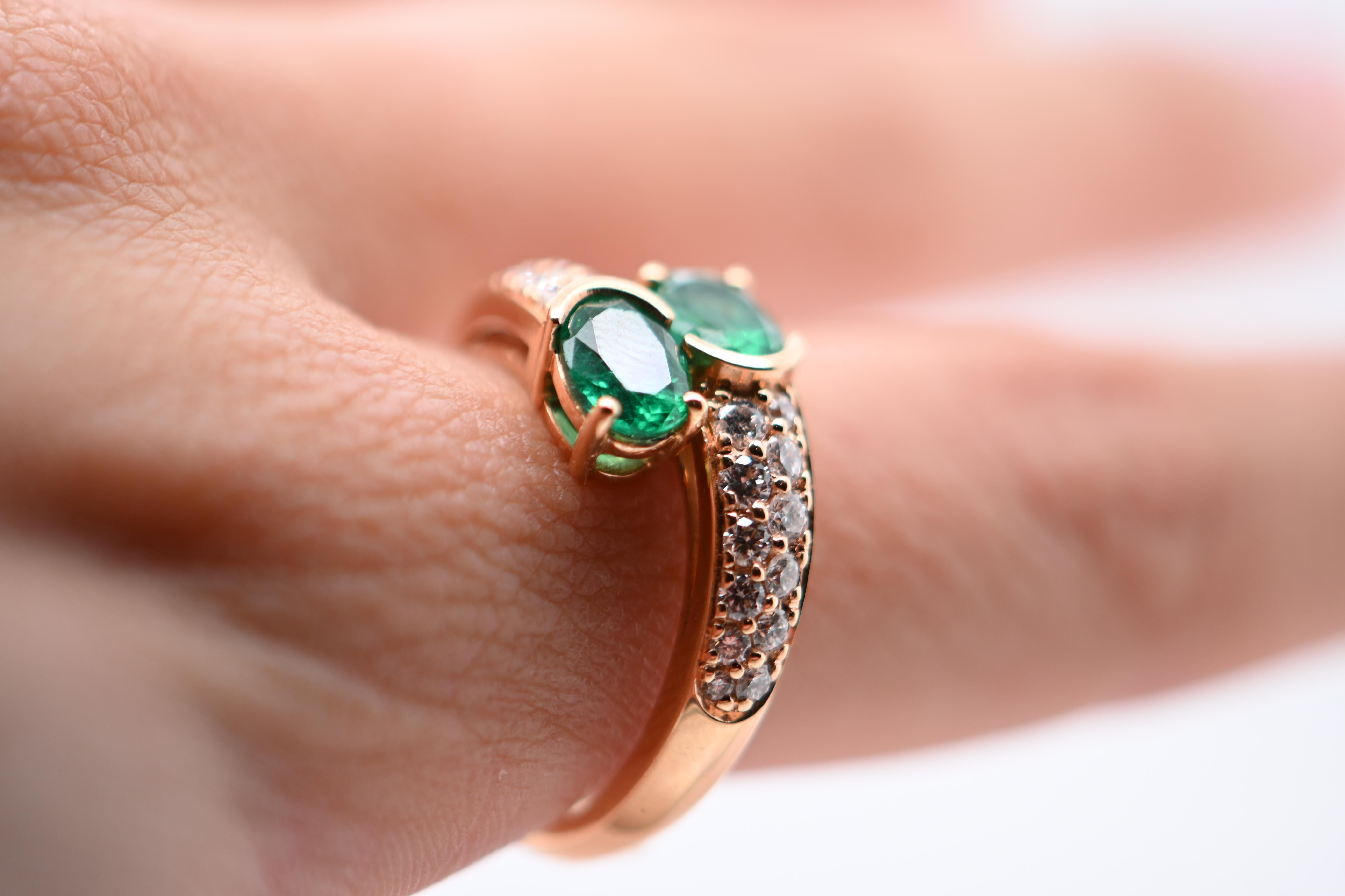 Experience the epitome of elegance with our Duo Ring, featuring two stunning oval-cut emeralds totaling 1.450 carats with a captivating V color. These exquisite gemstones are beautifully complemented by 24 brilliant-cut diamonds, weighing 0.640