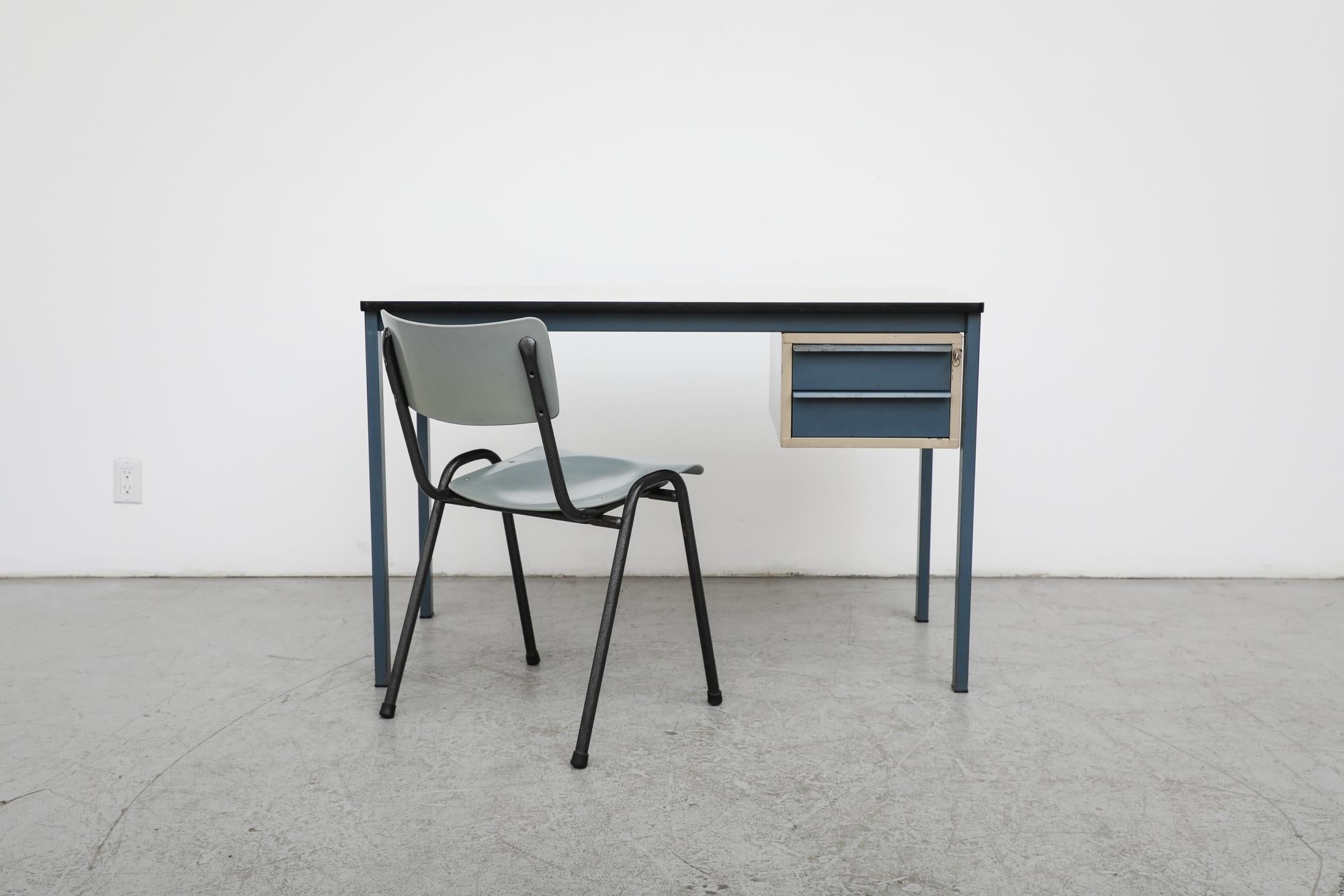 Duotone Ahrend De Cirkel metal desk. The desk has a formica top, blue legs and one side cabinet with two blue drawers. In original condition with visible wear, rust, dents and scratches. Wear is consistent with its age and use.