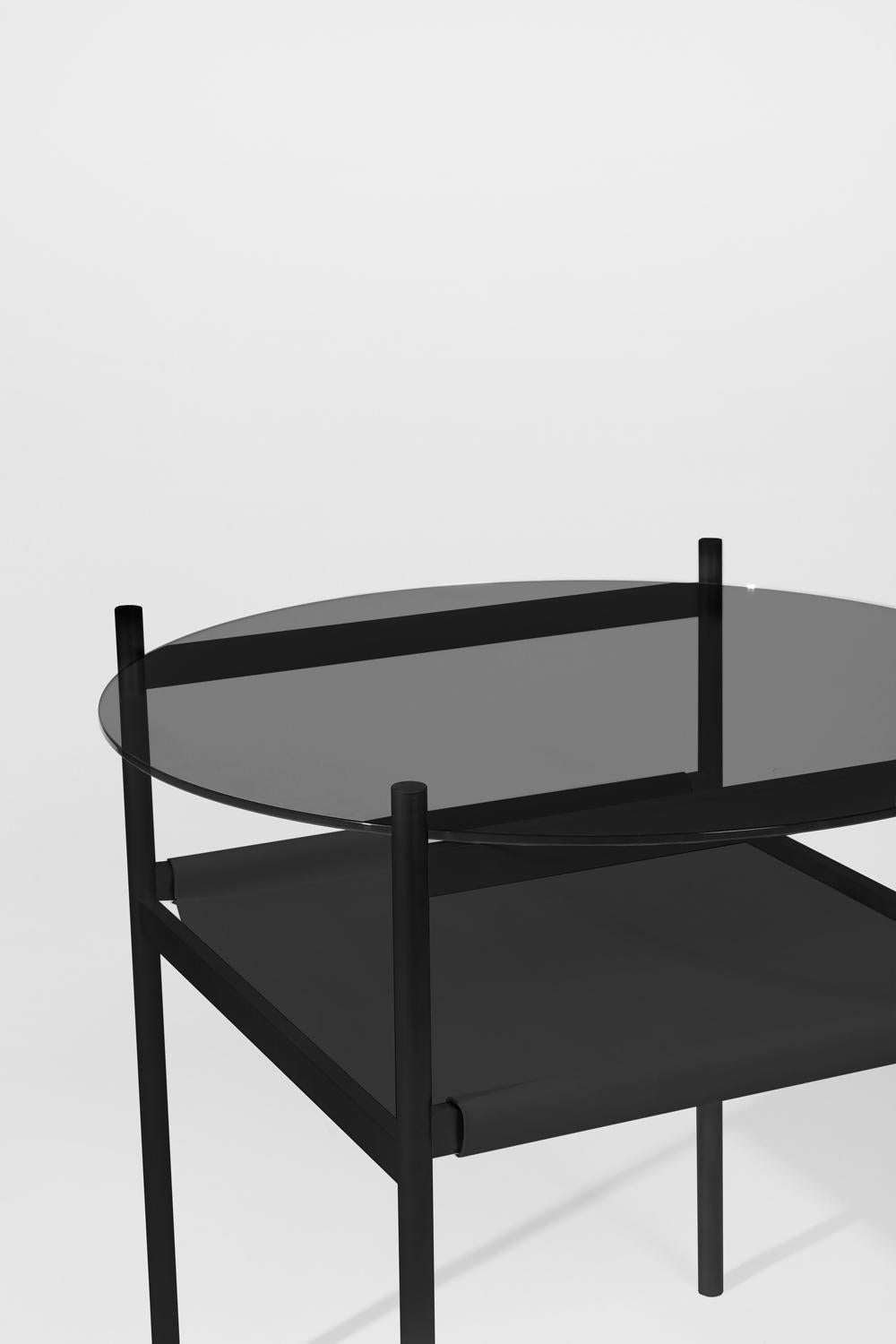 Made to order. Please allow 6 weeks for production.

Black frame / Smoked glass / Black leather sling.

The Duotone Furniture series is based on a modular hardware system that pairs sturdy construction with visual lightness and a range of