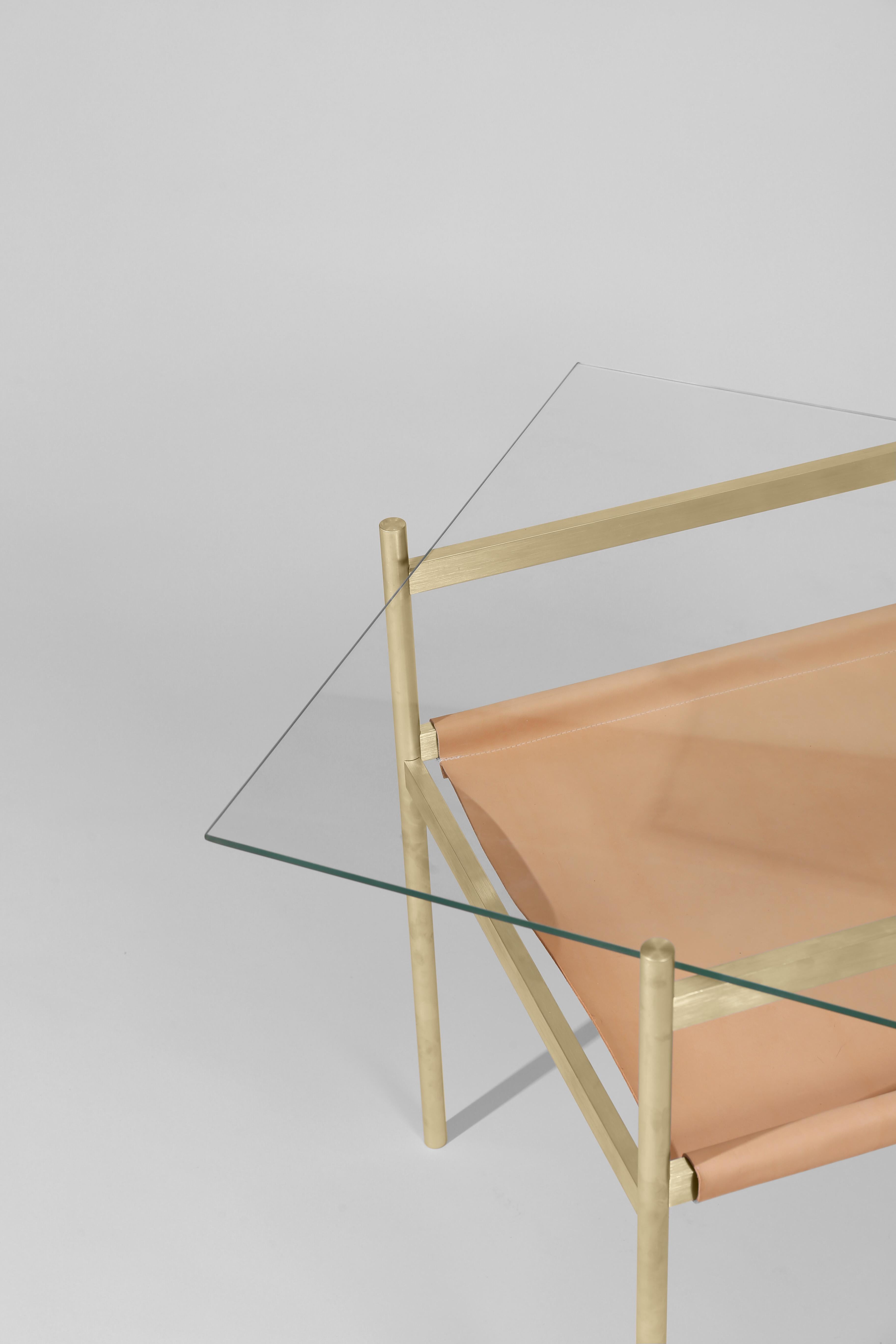 Made to order. Please allow six weeks for production.

Brass frame / Clear glass / Natural leather sling

The Duotone Furniture series is based on a modular hardware system that pairs sturdy construction with visual lightness and a range of