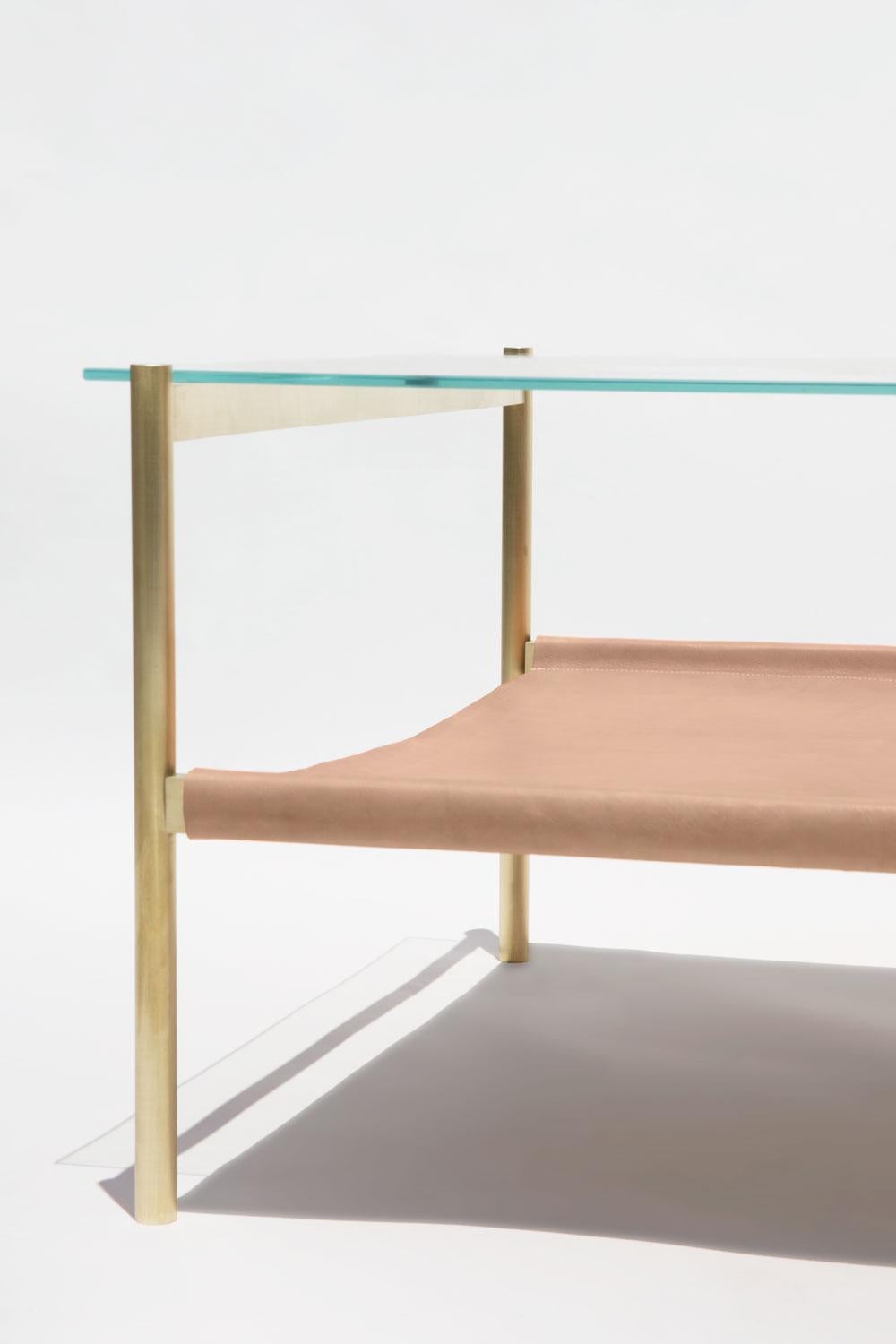 Made to order. Please allow 6 weeks for production.

Brass frame / Clear glass / Natural leather sling.

The Duotone Furniture series is based on a modular hardware system that pairs sturdy construction with visual lightness and a range of