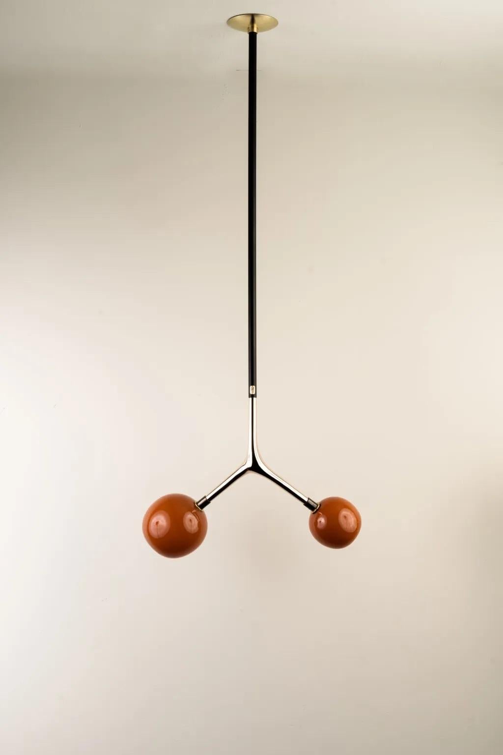 Vermilion Dupla Pendant Lamp by Isabel Moncada
Dimensions: W 45 x D 20 x H 125 cm.
Materials: Brass, cast bronze and blown glass.

Dupla hangs from the ceiling just like a branch with its fruits. The customizable length options allow play with scale