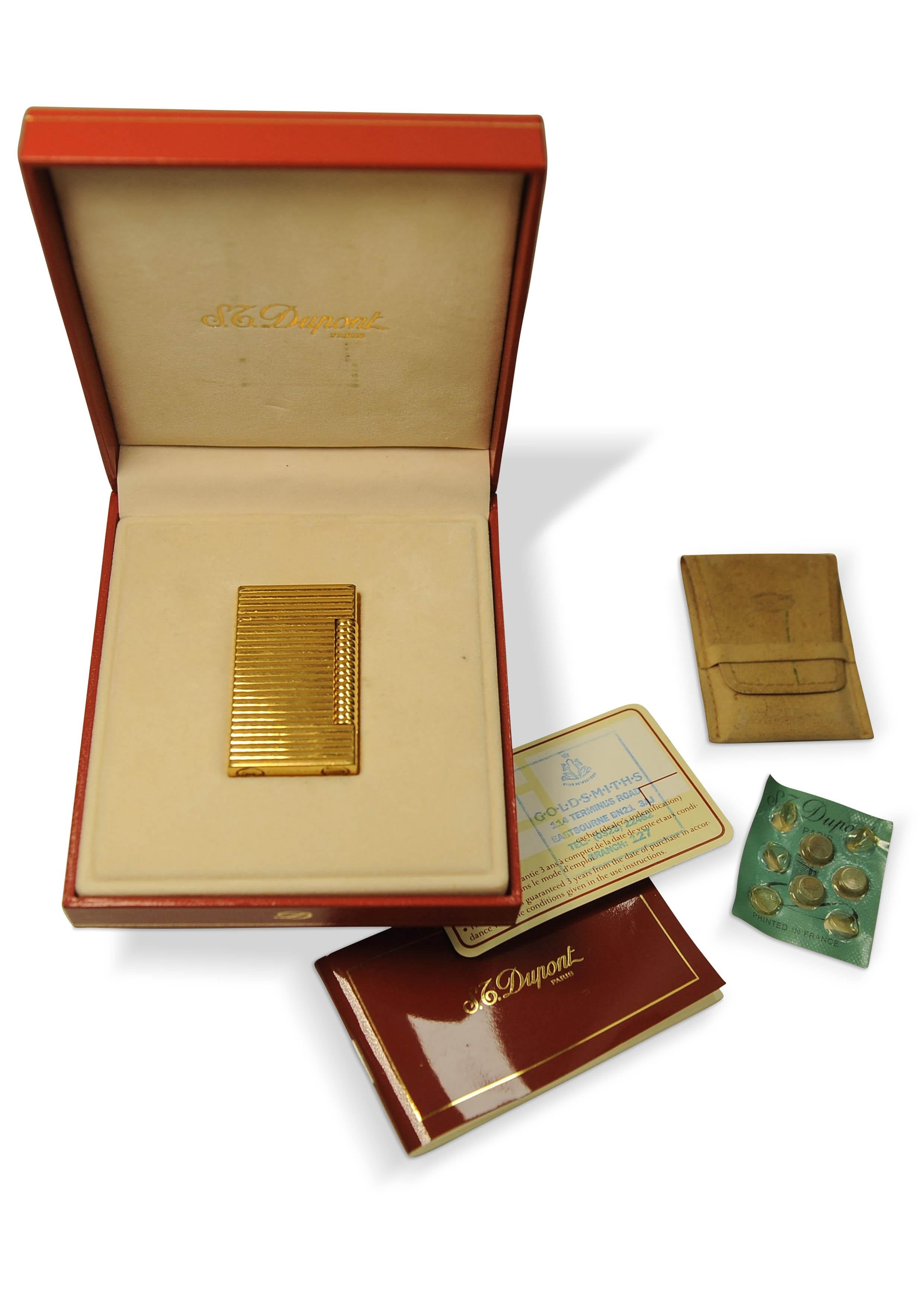 S.T. Dupont 18 Carat Gold Plated Briquet De Poche LD Plaque Gas Cigarette Lighter With Original Box and Papers 

Stamped 100NL95 
No 2294

Made in Paris, France 
Purchase receipt shoes 4/2/1995 Goldsmith, Eastbourne, UK 

