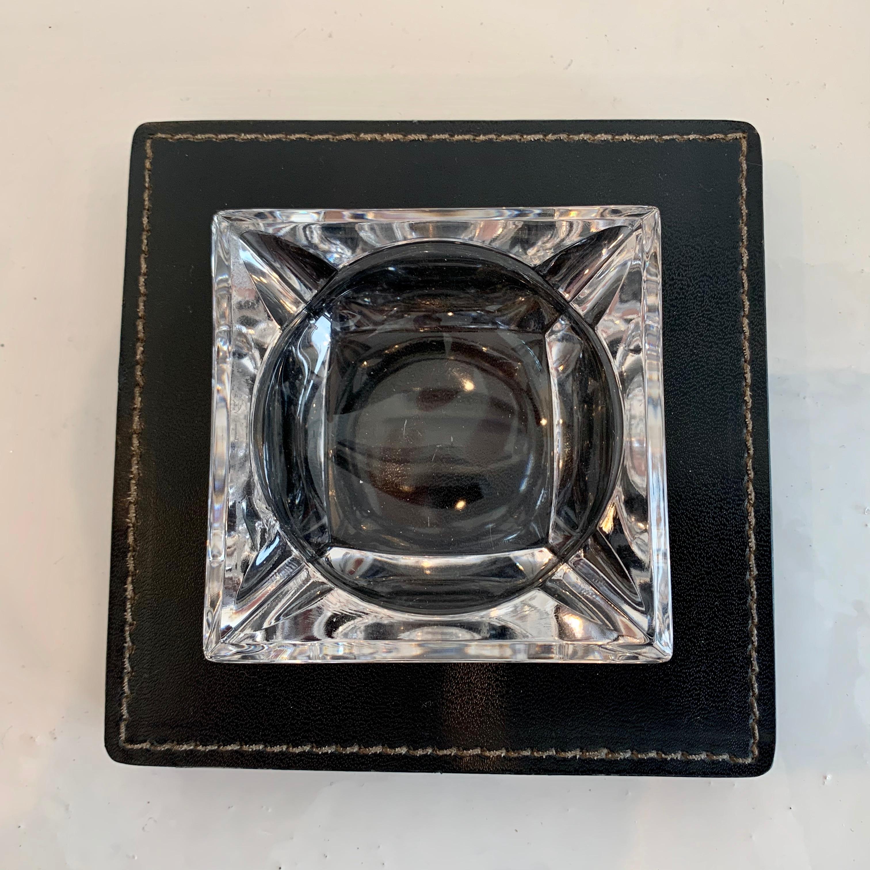Elegant ashtray in the style of Dupre-Lafon. Black stacked leather base with removable glass dish. Contrast stitching. Classic design, great condition.